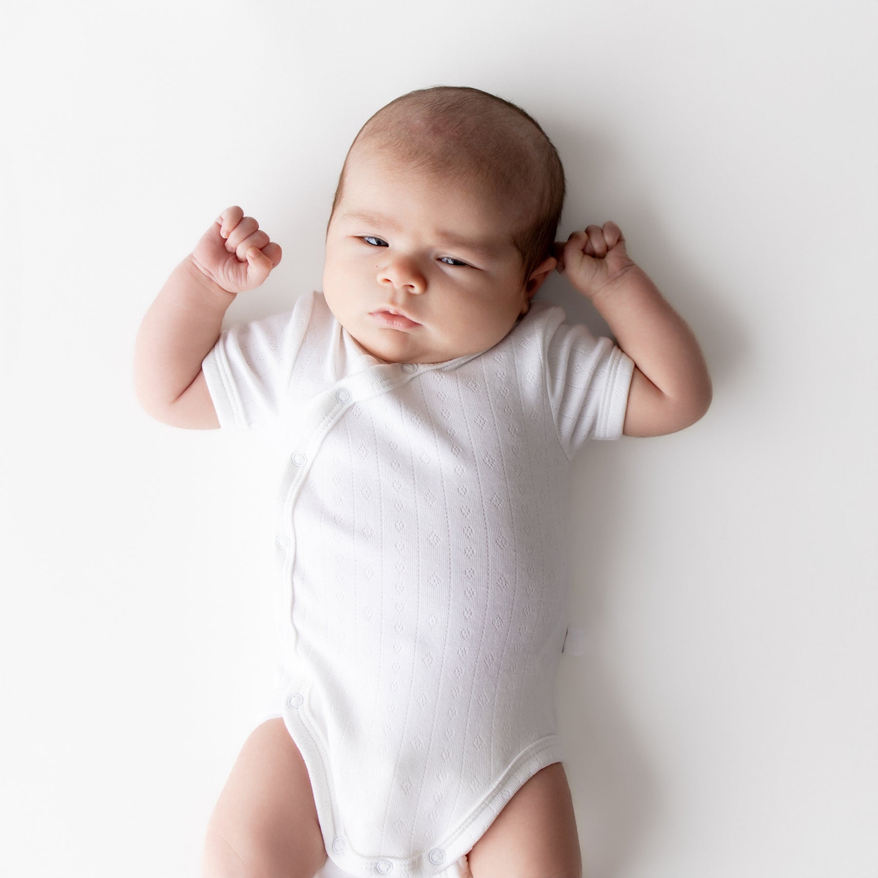 Close up of newborn wearing the Pointelle Kimono Bodysuit in Cloud