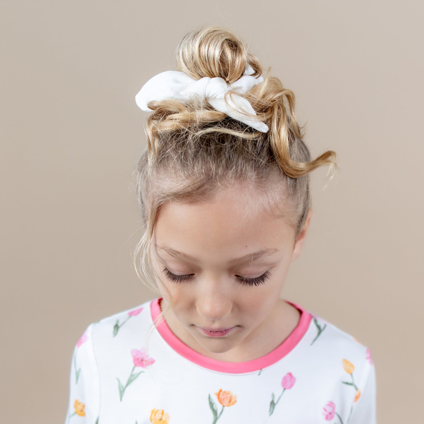 Scrunchie in Cloud shown in a young girls hair