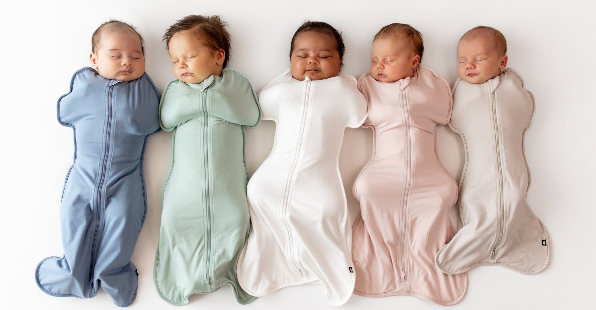 Five babies sleeping in colorful swaddles on a white background