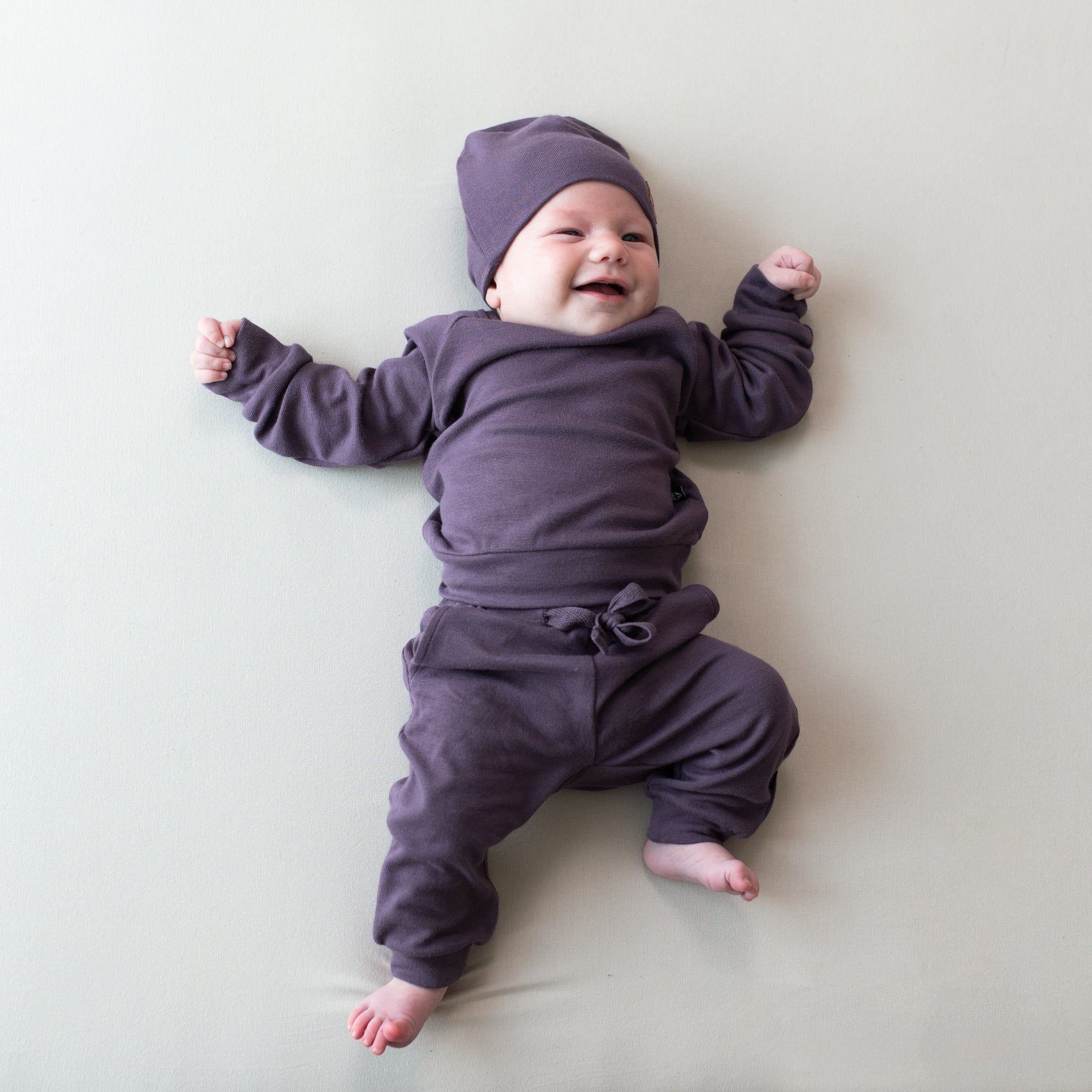 baby in currant bamboo jersey jogger set and matching beanie