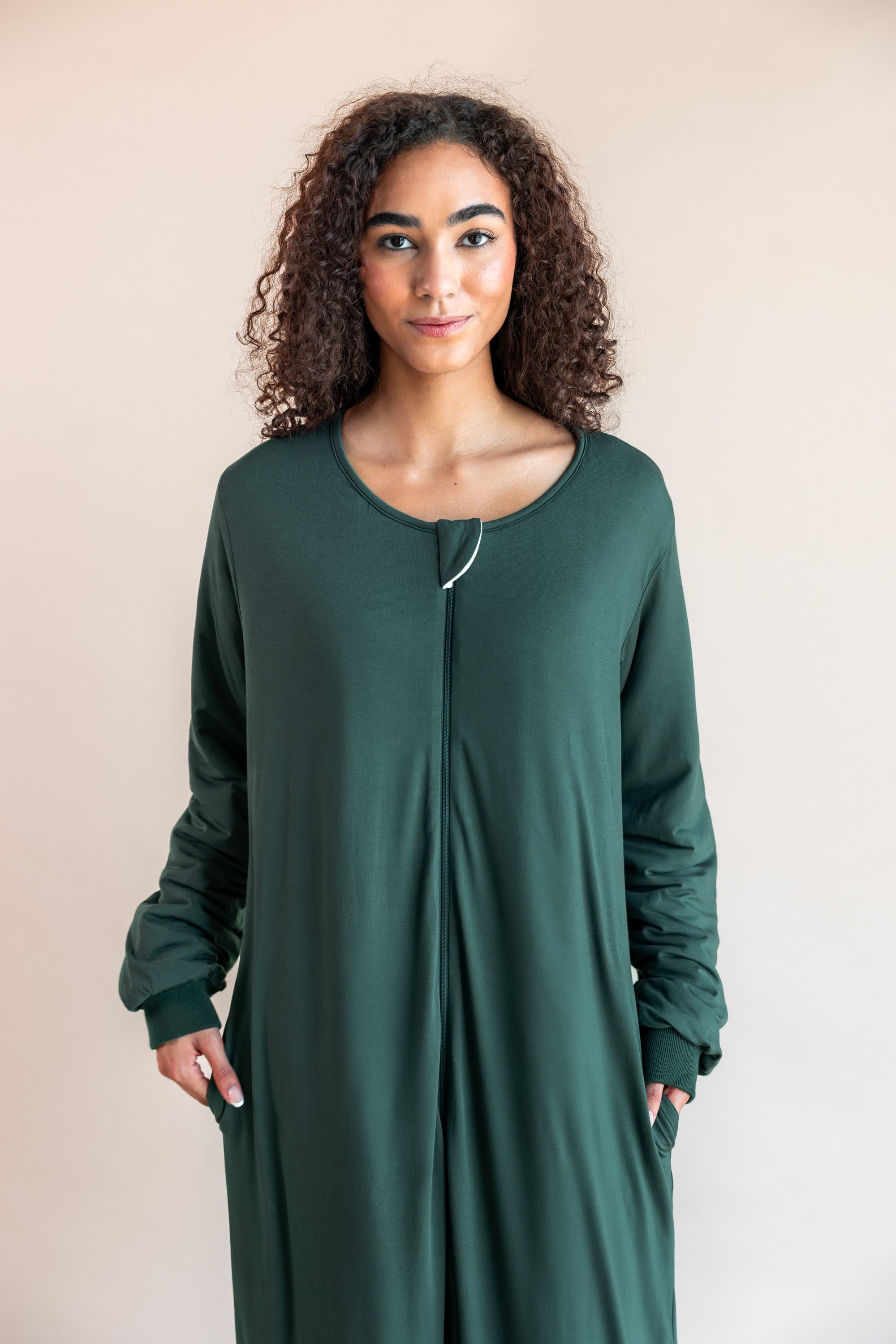 Women wearing sleep bag walker with sleeves in cypress color on a beige background