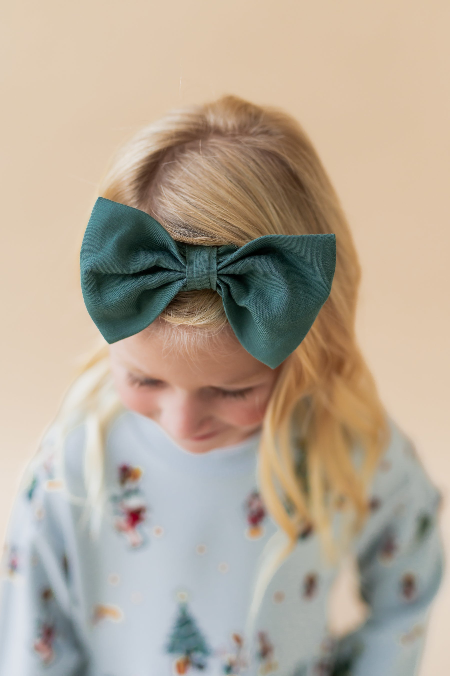 Girl wearing Bow Headband in Cypress color on her head