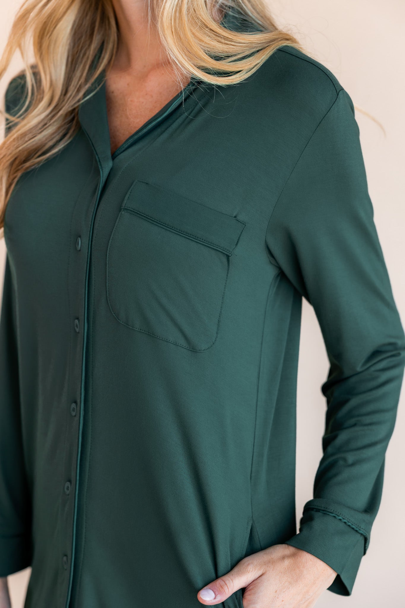 Woman wearing women's sleep shirt in cypress color on a beige background