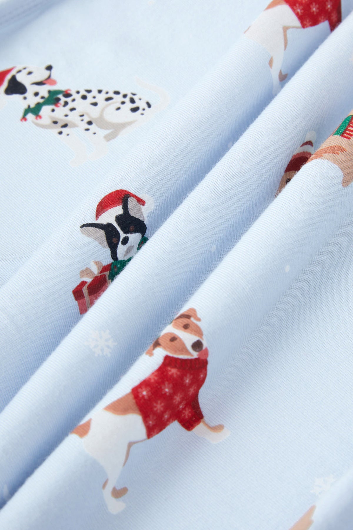 Close up of blue fabric with Holiday pups print on it
