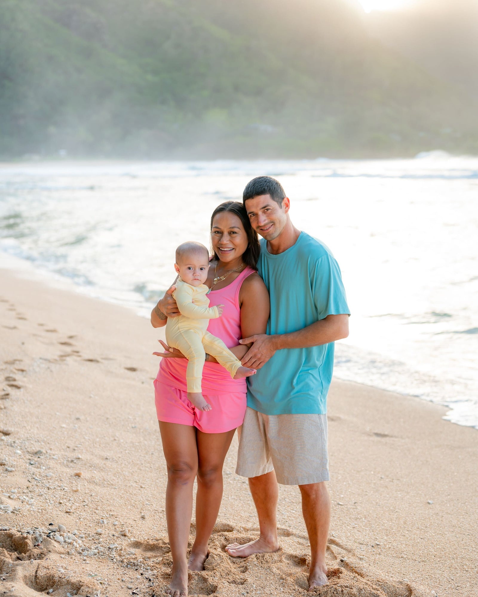 Family on beach in Kyte Baby Spring Solids 