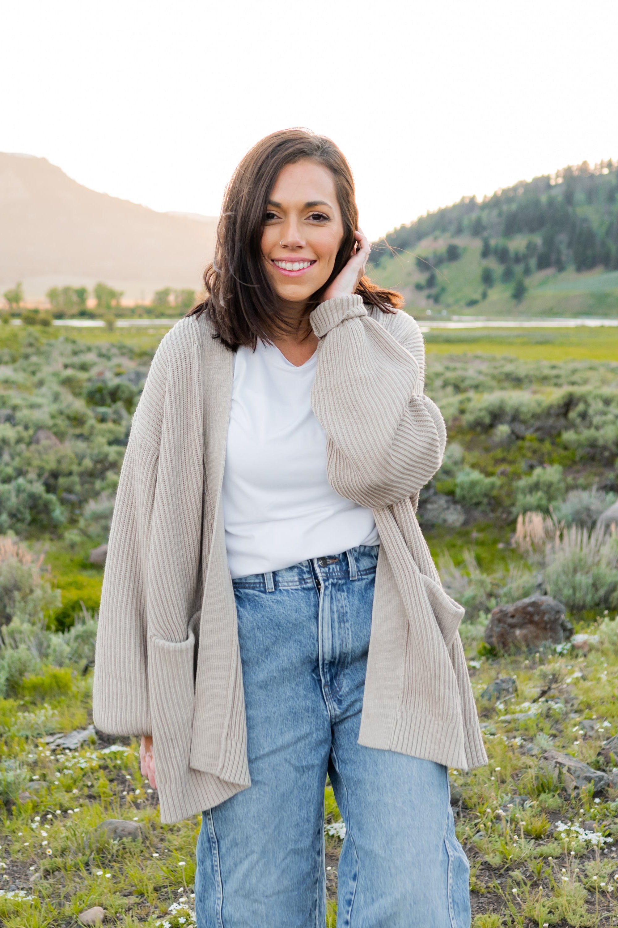 Woman wearing Chunky Knit Women's Oversized Cardigan in Oat in Yellowstone National park