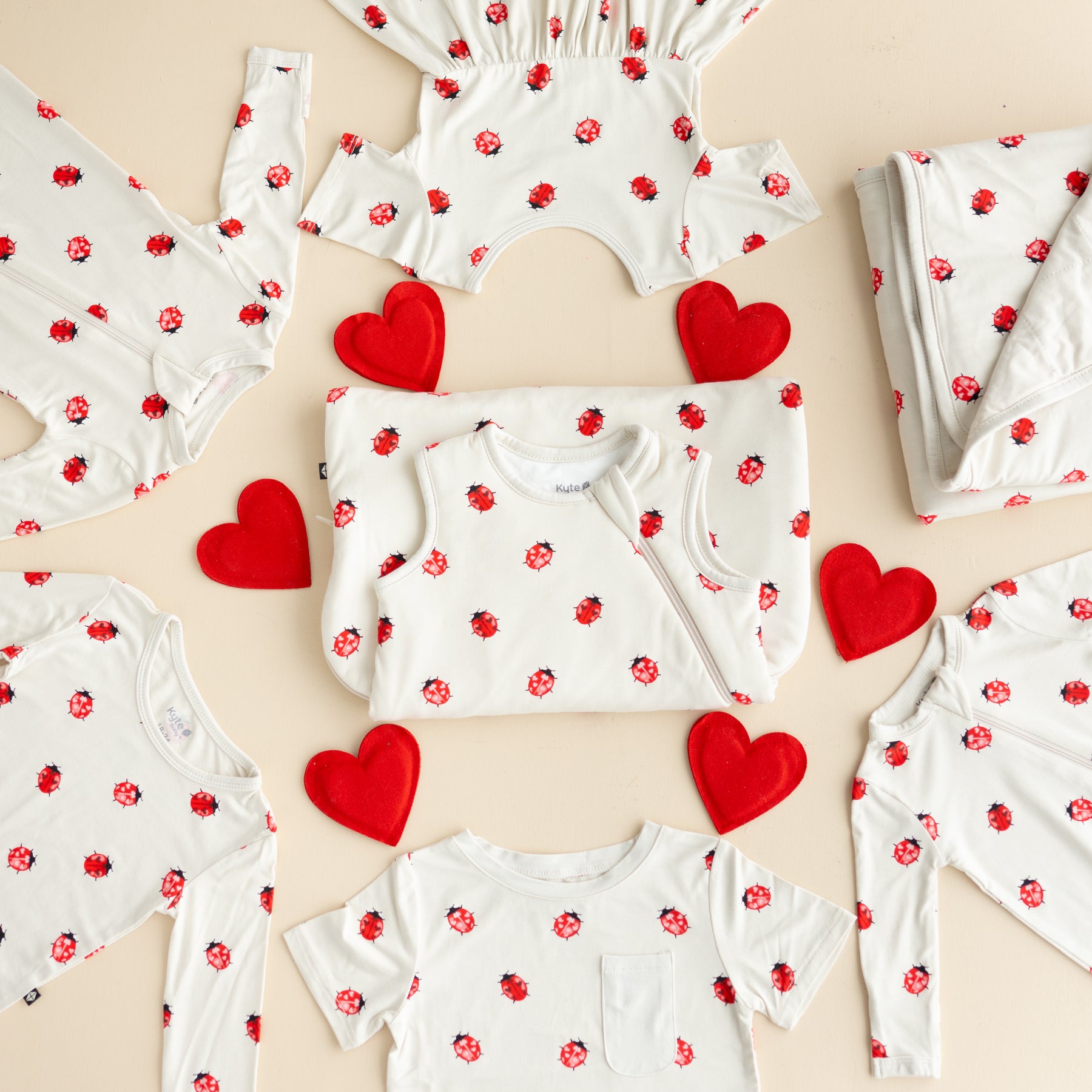 Love Bug flay lay of products with small red hearts