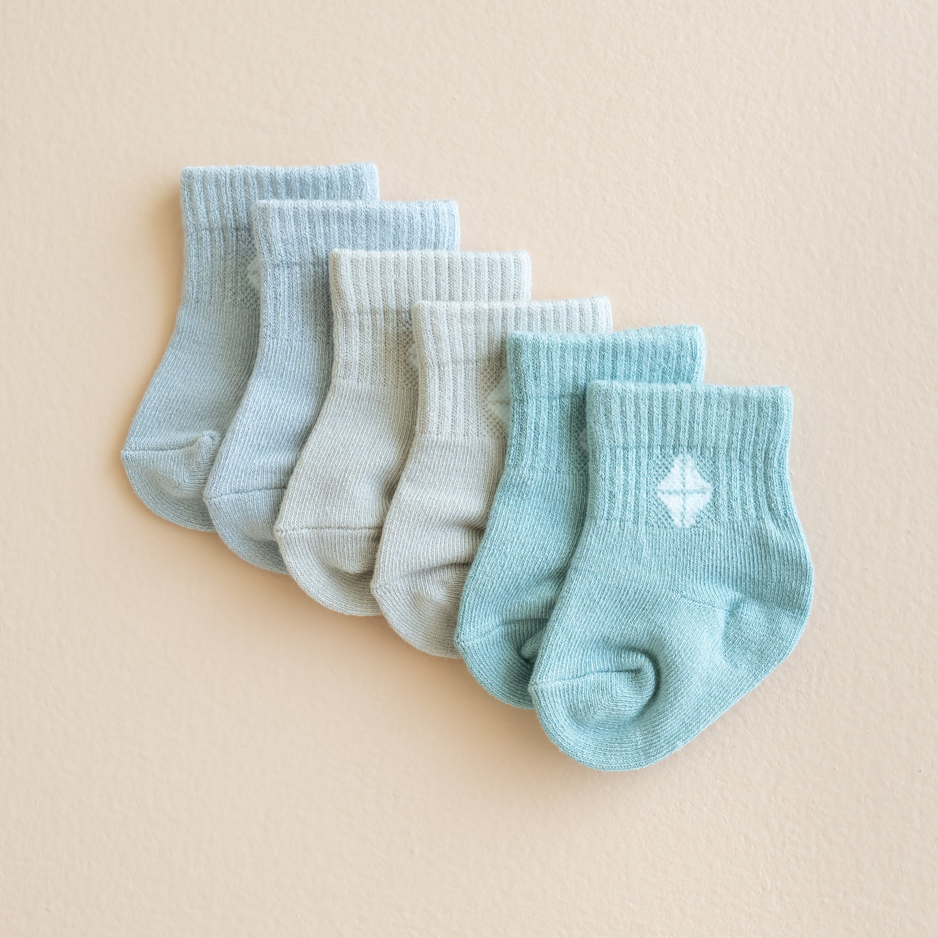 Flat lay of the Crew Socks Combo 3-Pack in Neutral showing colors Storm, Oat and Sage