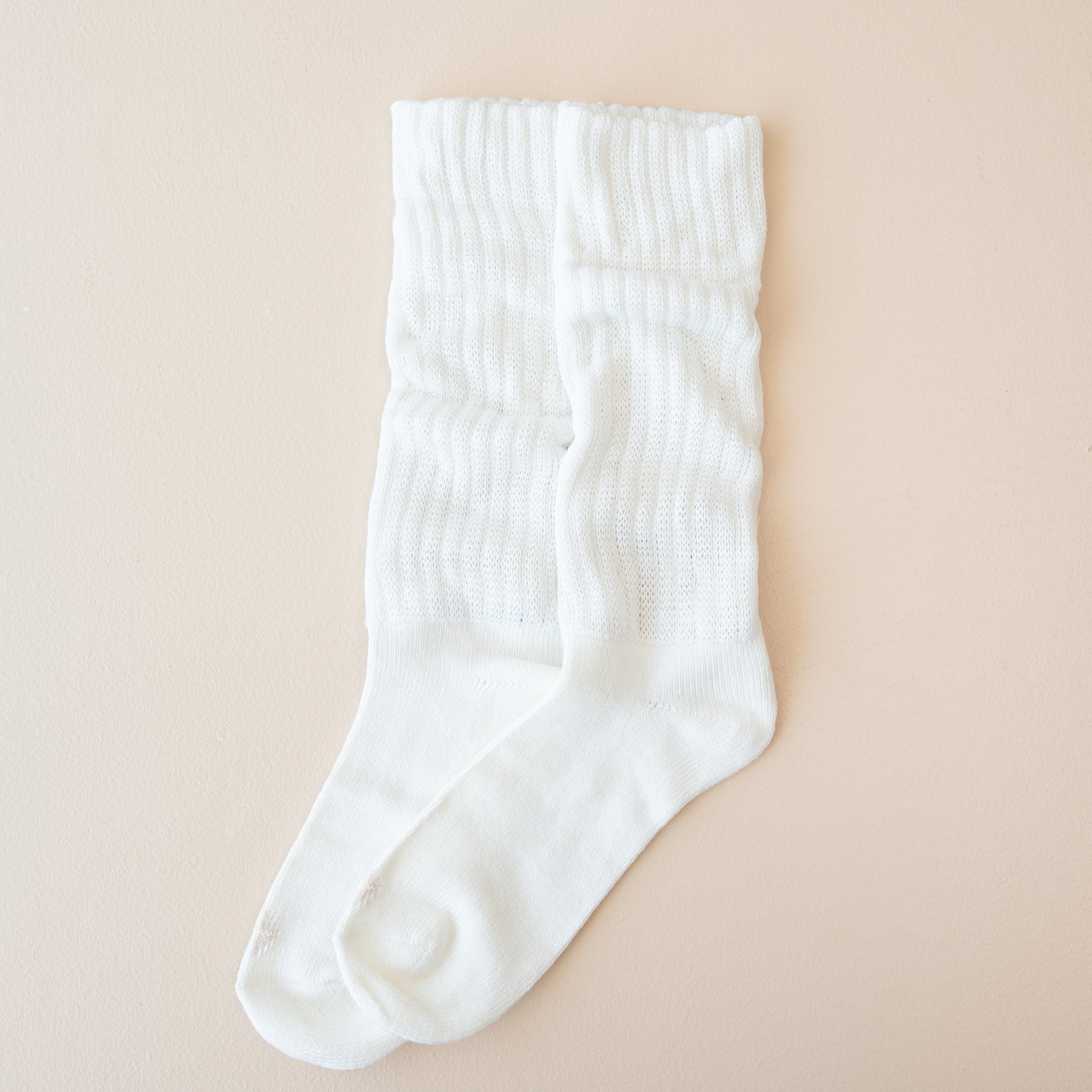 Adult Scrunch Socks in Cloud shown out of package laid side by side on a light neutral background
