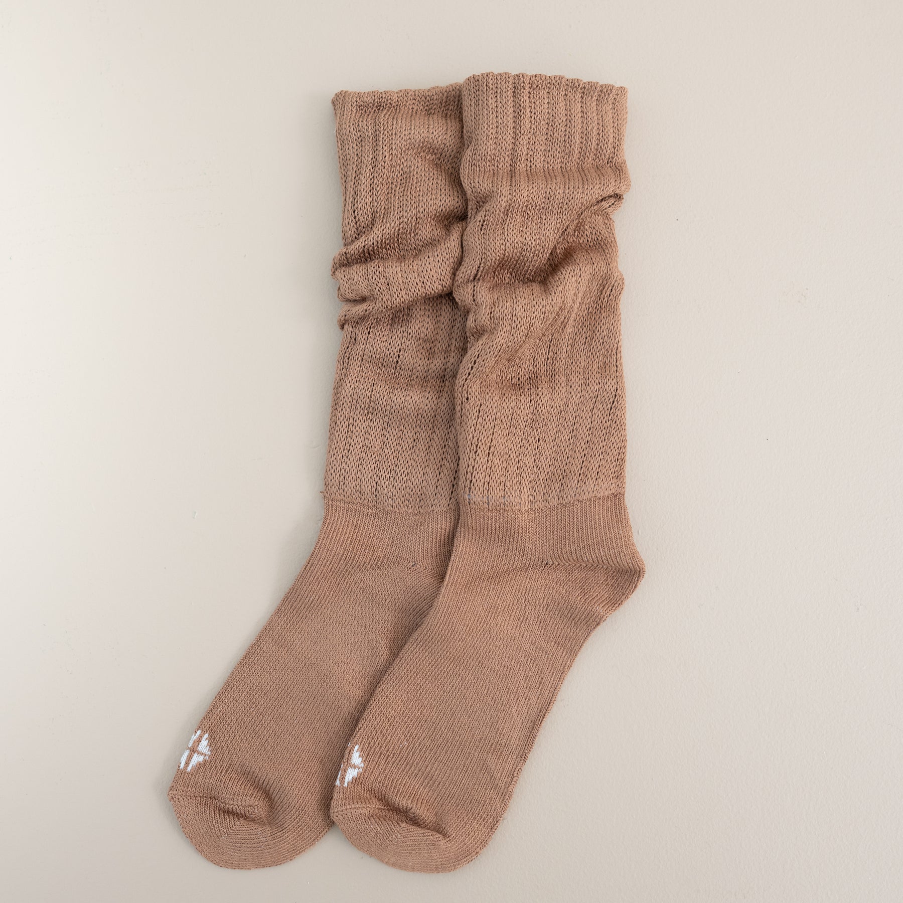 Adult Scrunch Socks in Latte shown out of package laid side by side on a light neutral background