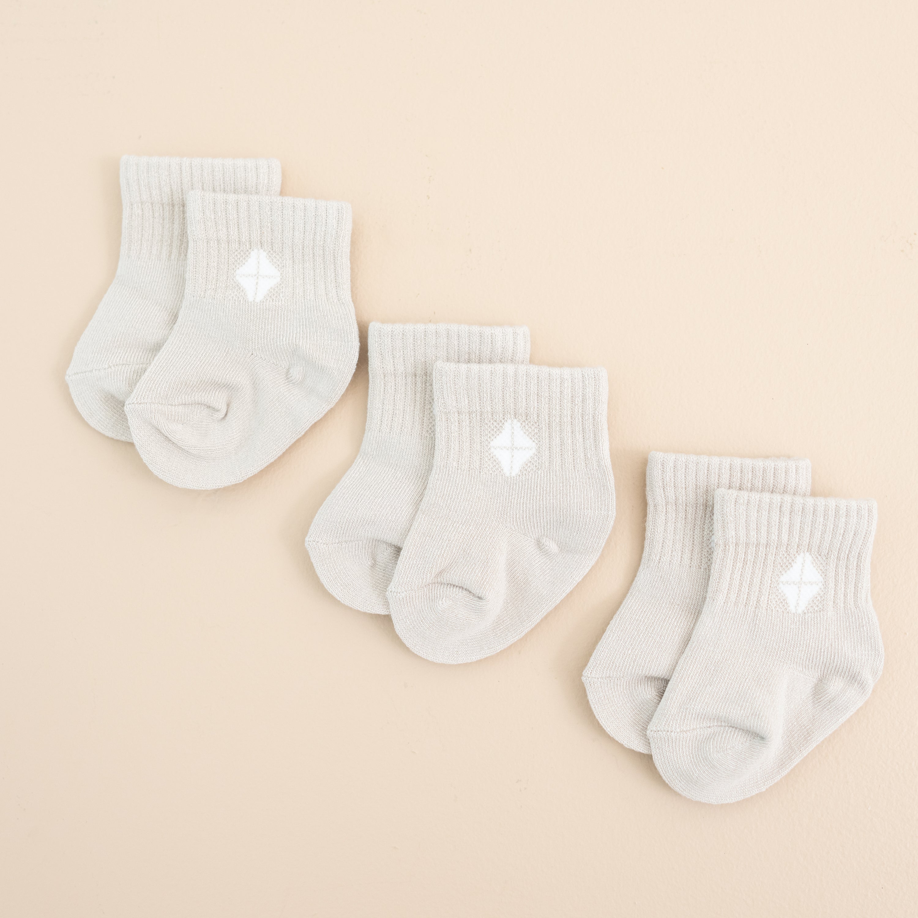 Photo of the Crew Socks Combo 3-Pack in Oat laid out side by side on a light neutral background