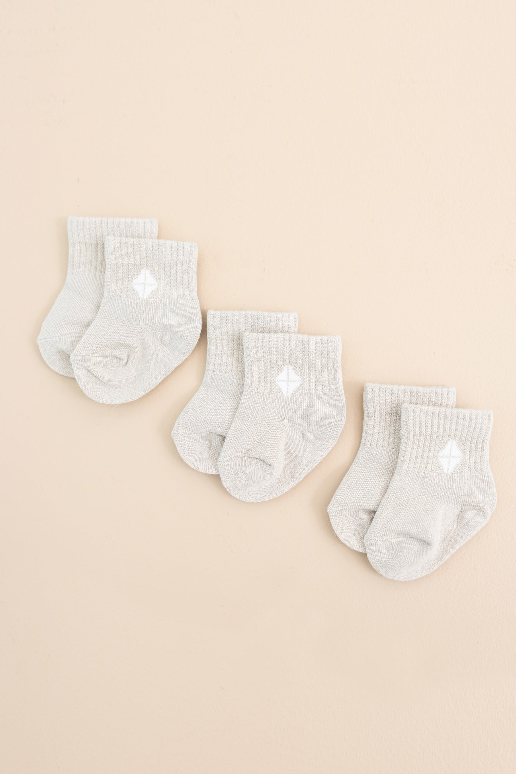 Photo of the Crew Socks Combo 3-Pack in Oat laid out side by side on a light neutral background