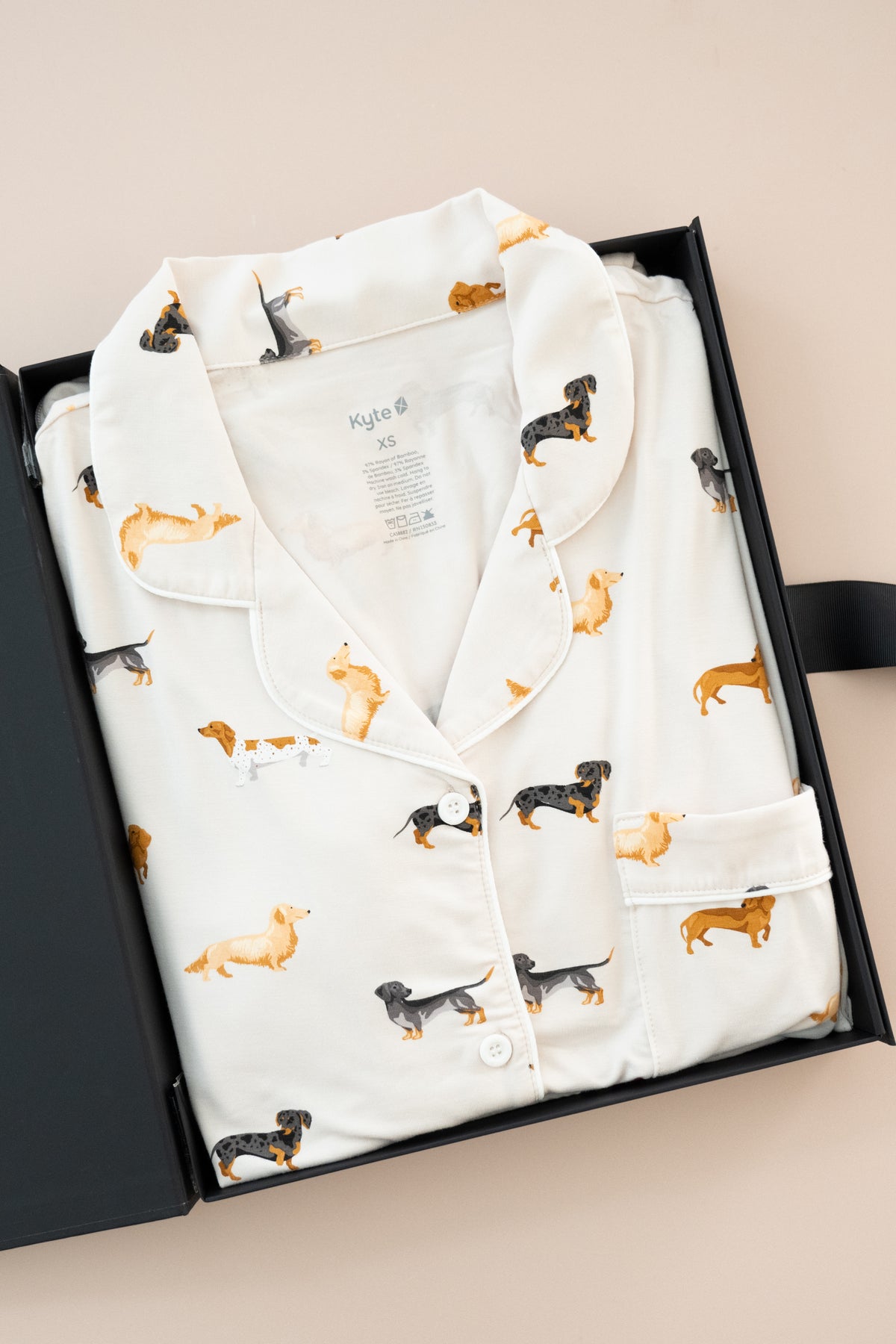 Long-Sleeved Women's Pajama Set in Dachshund print packed in a box on a beige background