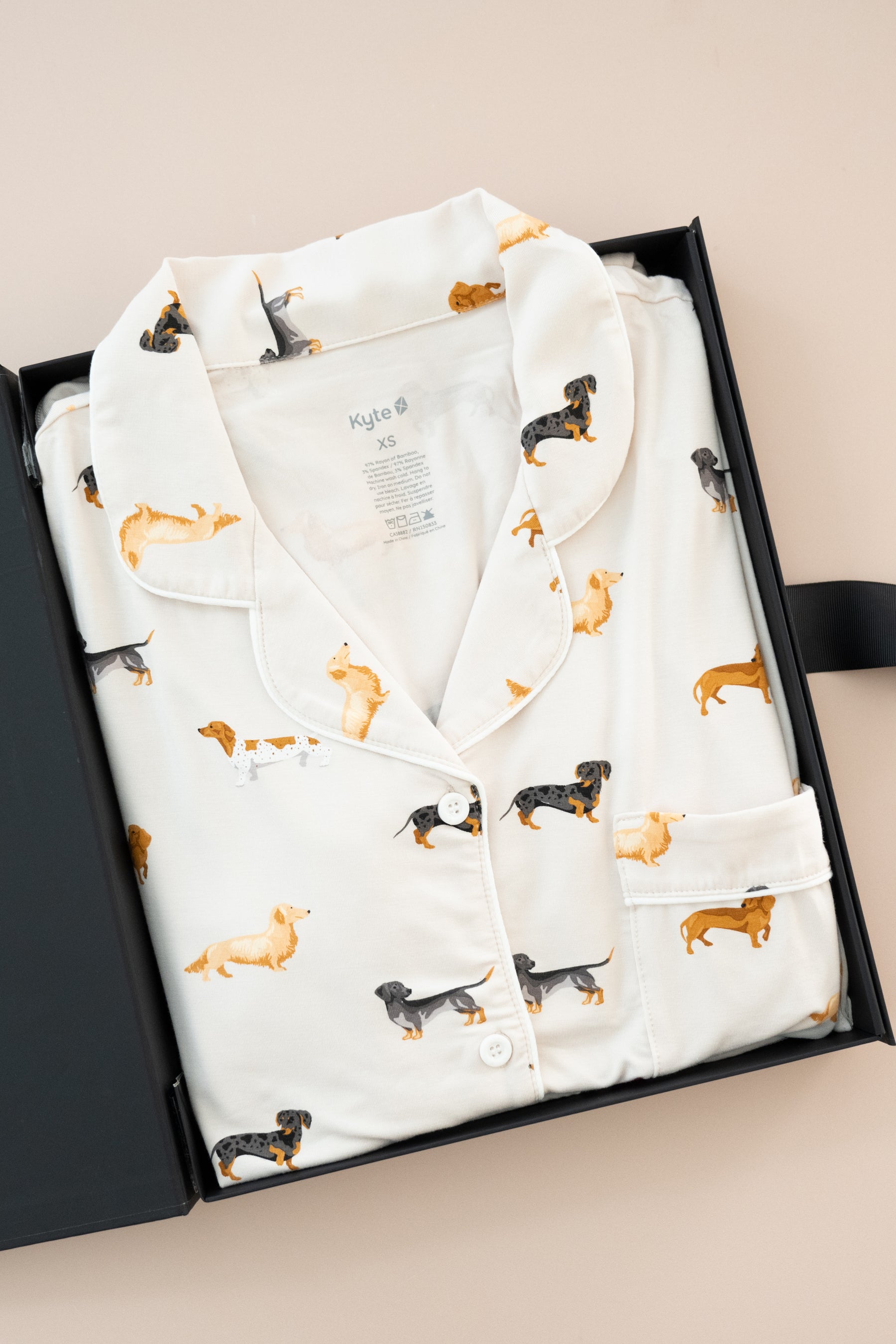 Women's Short Sleeve Pajama Set in Dachshund print packed in a box on a beige background
