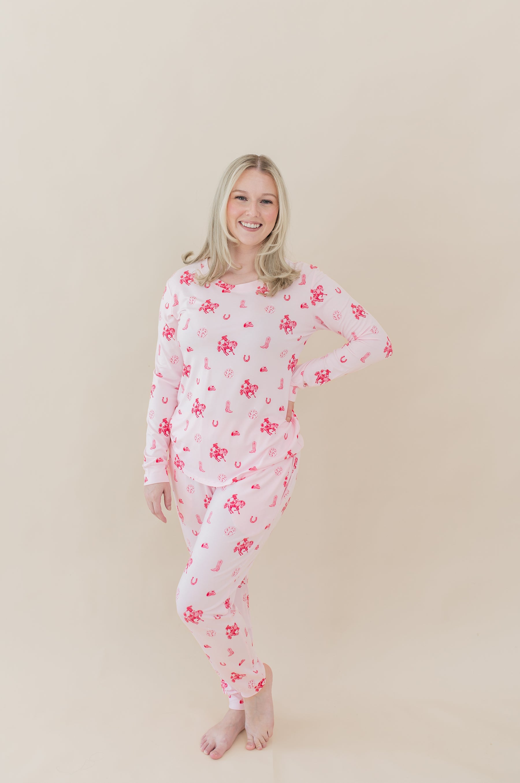 Female modeling the Women's Jogger Pajama Set in Disco Cowgirl with one hand on her hip in front of a light taupe backdrop