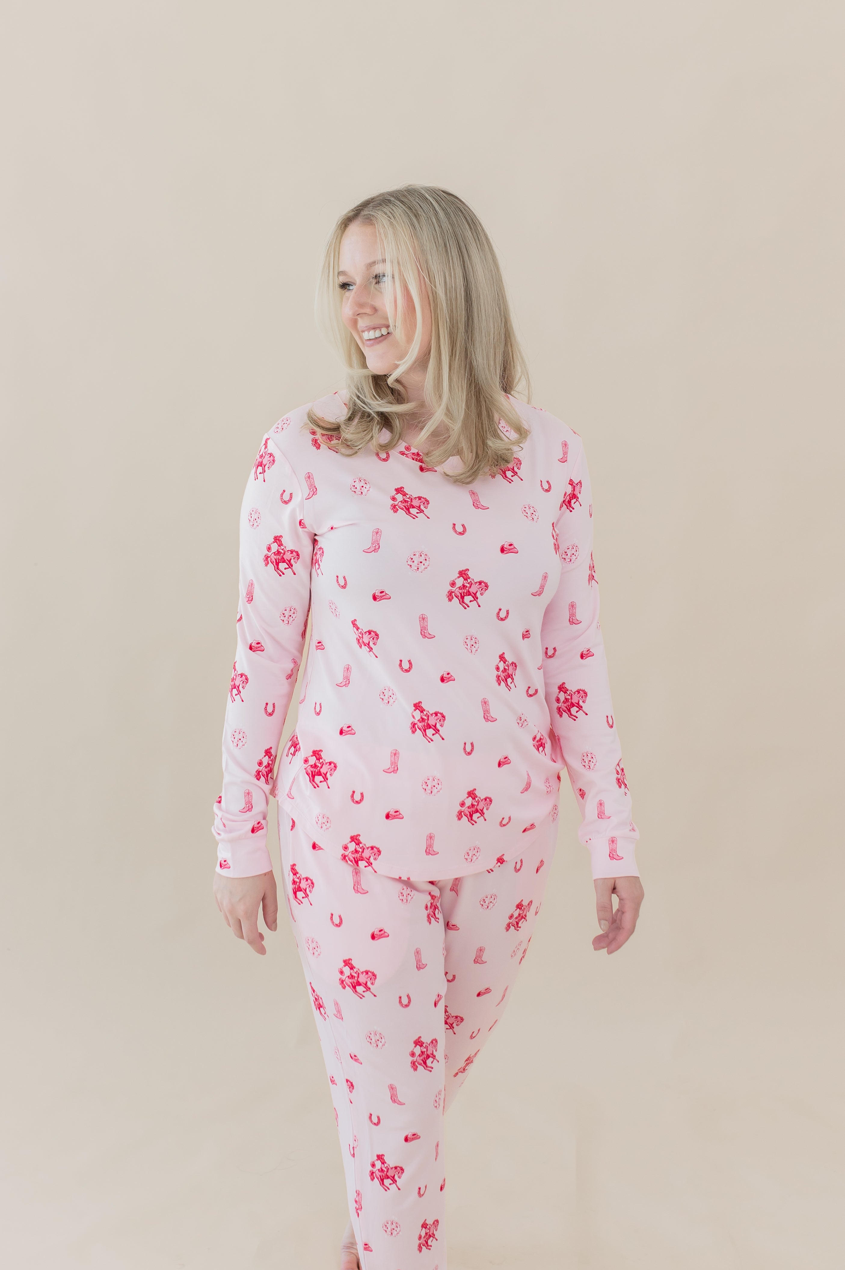 Female walking wearing the Women's Jogger Pajama Set in Disco Cowgirl in front of a cream colored background