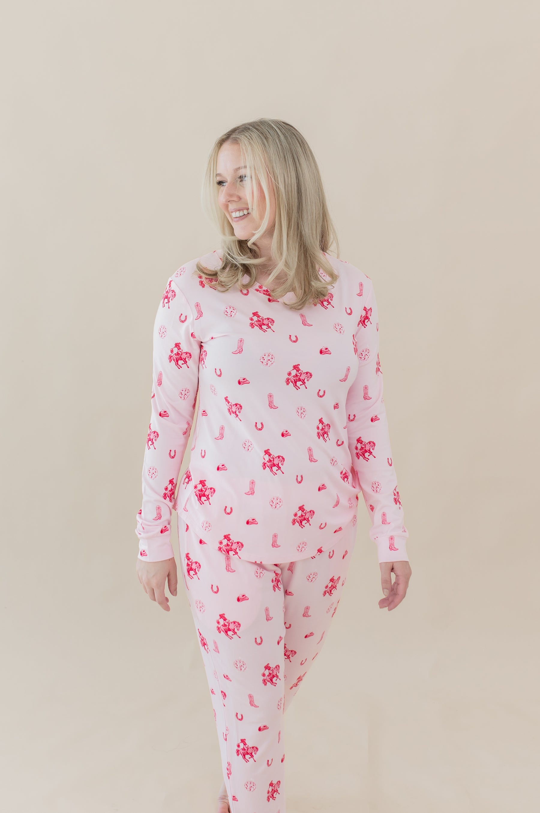 Female walking wearing the Women's Jogger Pajama Set in Disco Cowgirl in front of a cream colored background