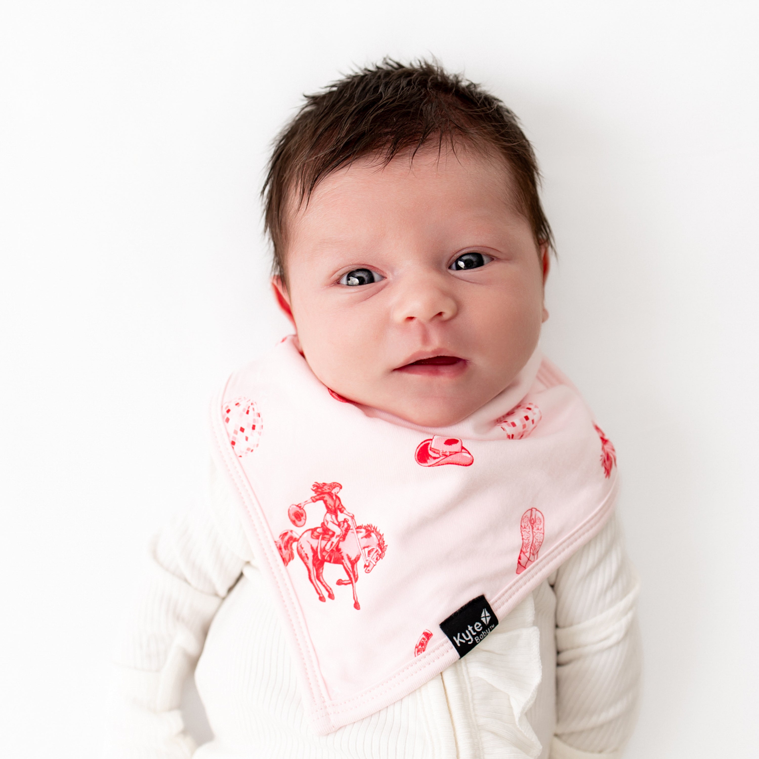 Close up of newborn wearing the Bib in Disco Cowgirl 