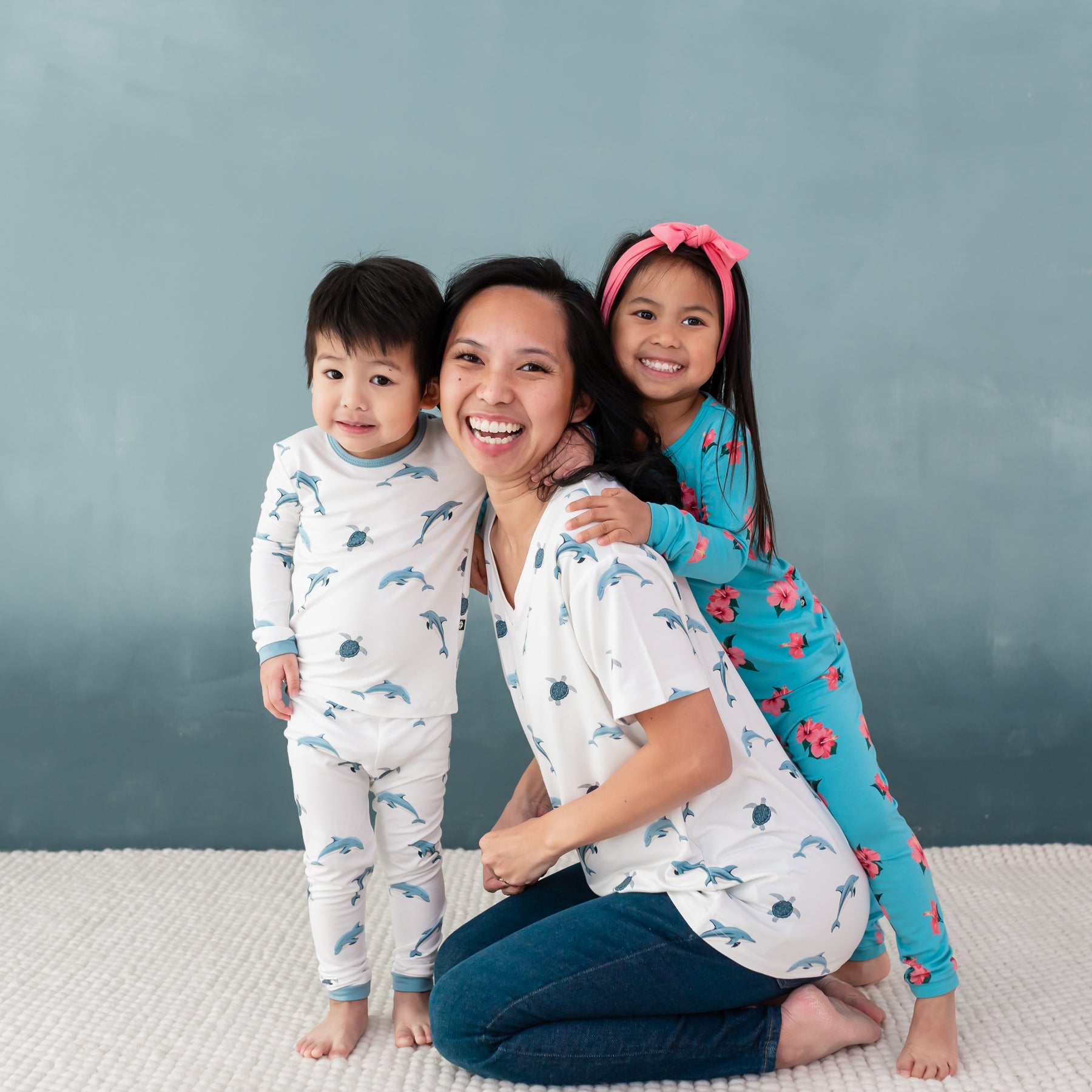 Family modeling Kyte clothing in Dolphin and Hibiscus  