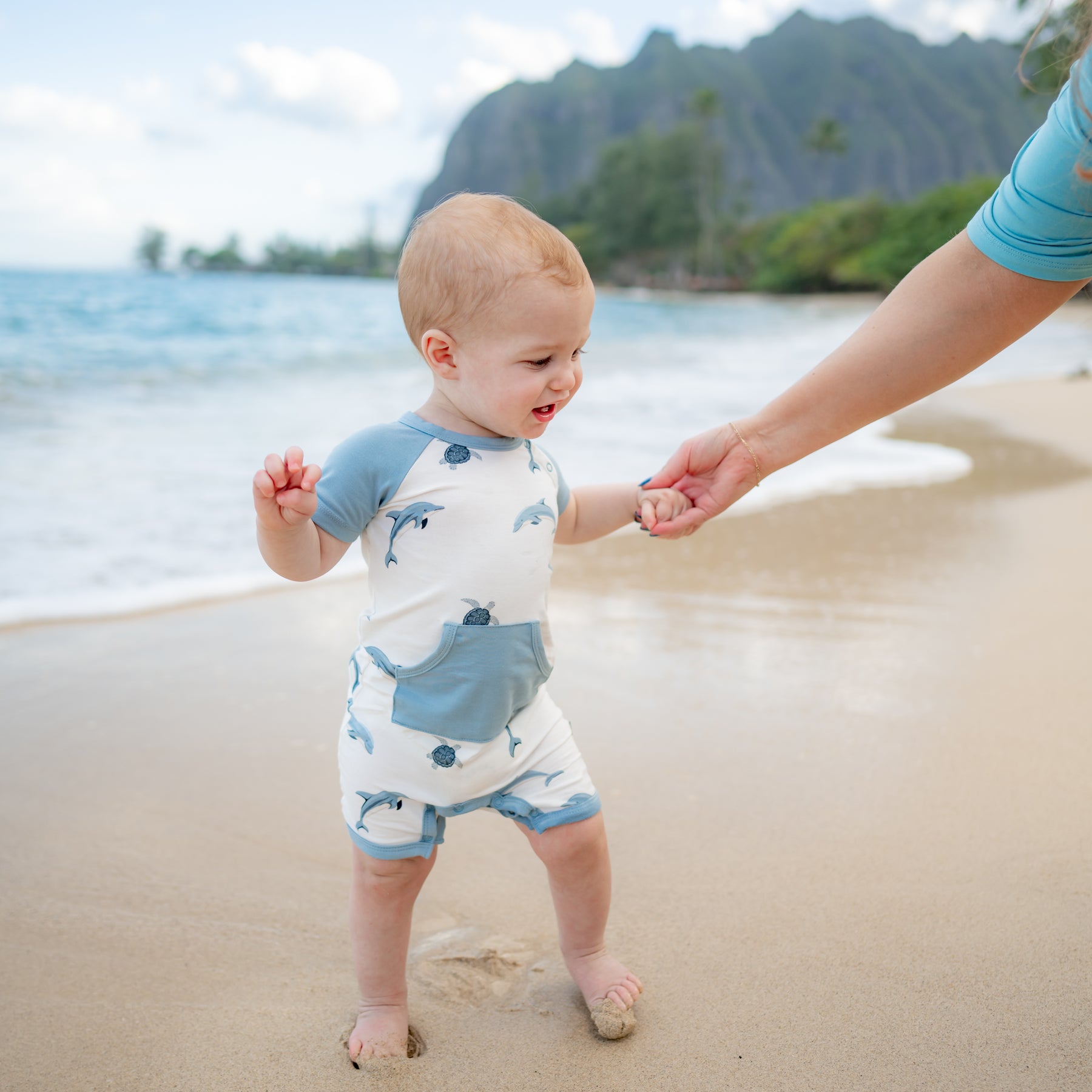 baby modeling kyte dolphin shortall on the beach