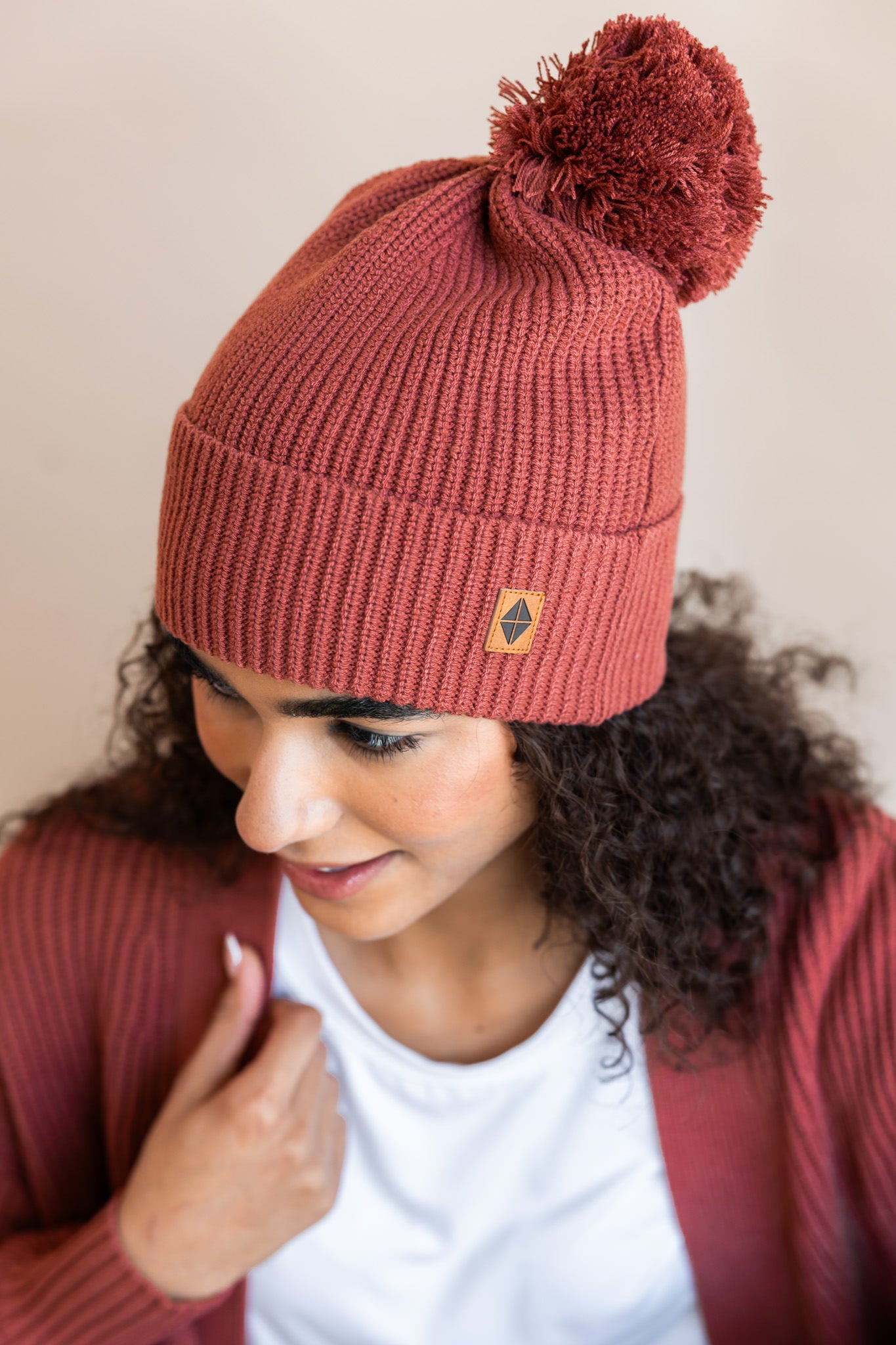 Modal wearing Chunky Knit Adult Pom in Ember on a beige background