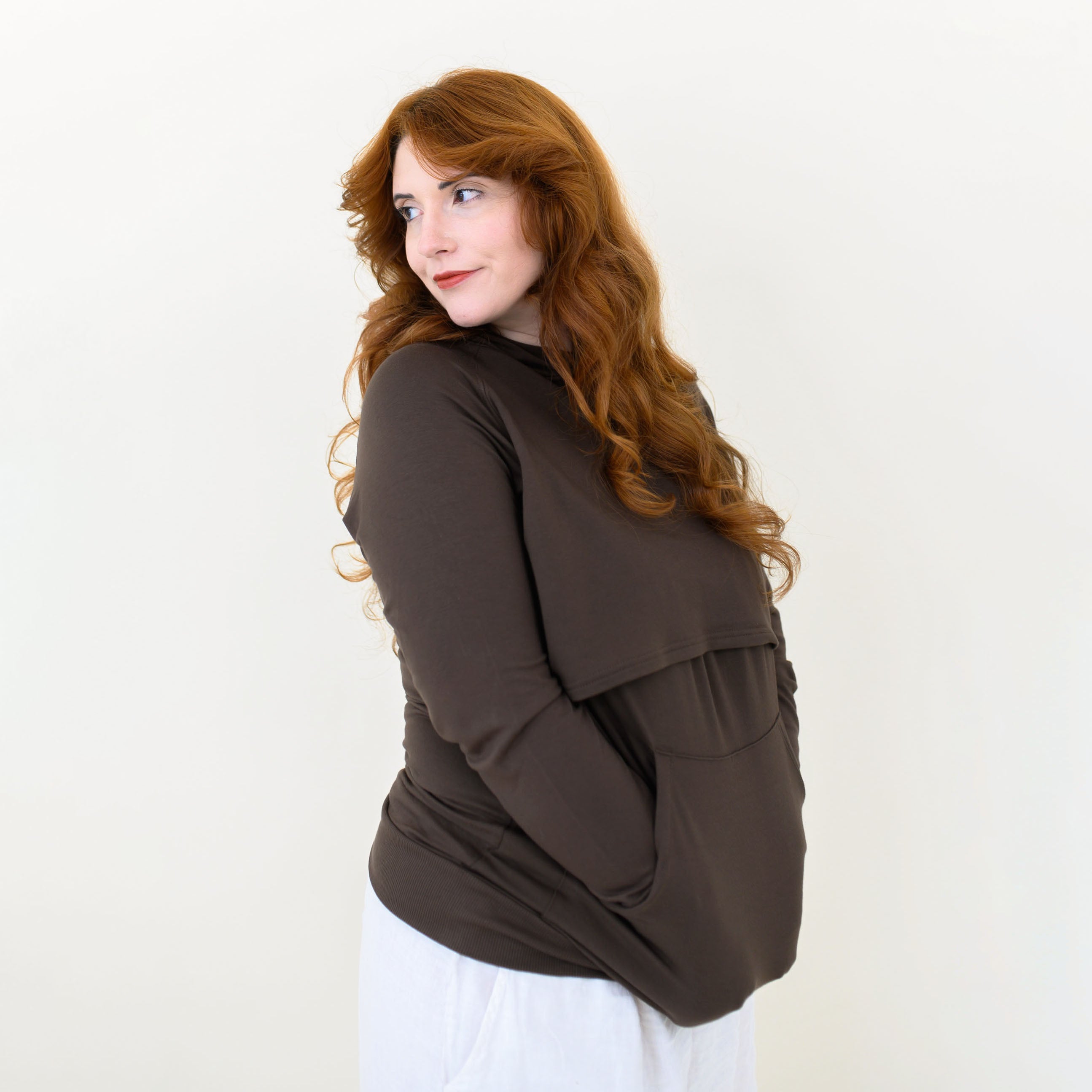 Female modeling the Women's French Terry Nursing Hoodie in Espresso with her hands in the kangaroo pocket
