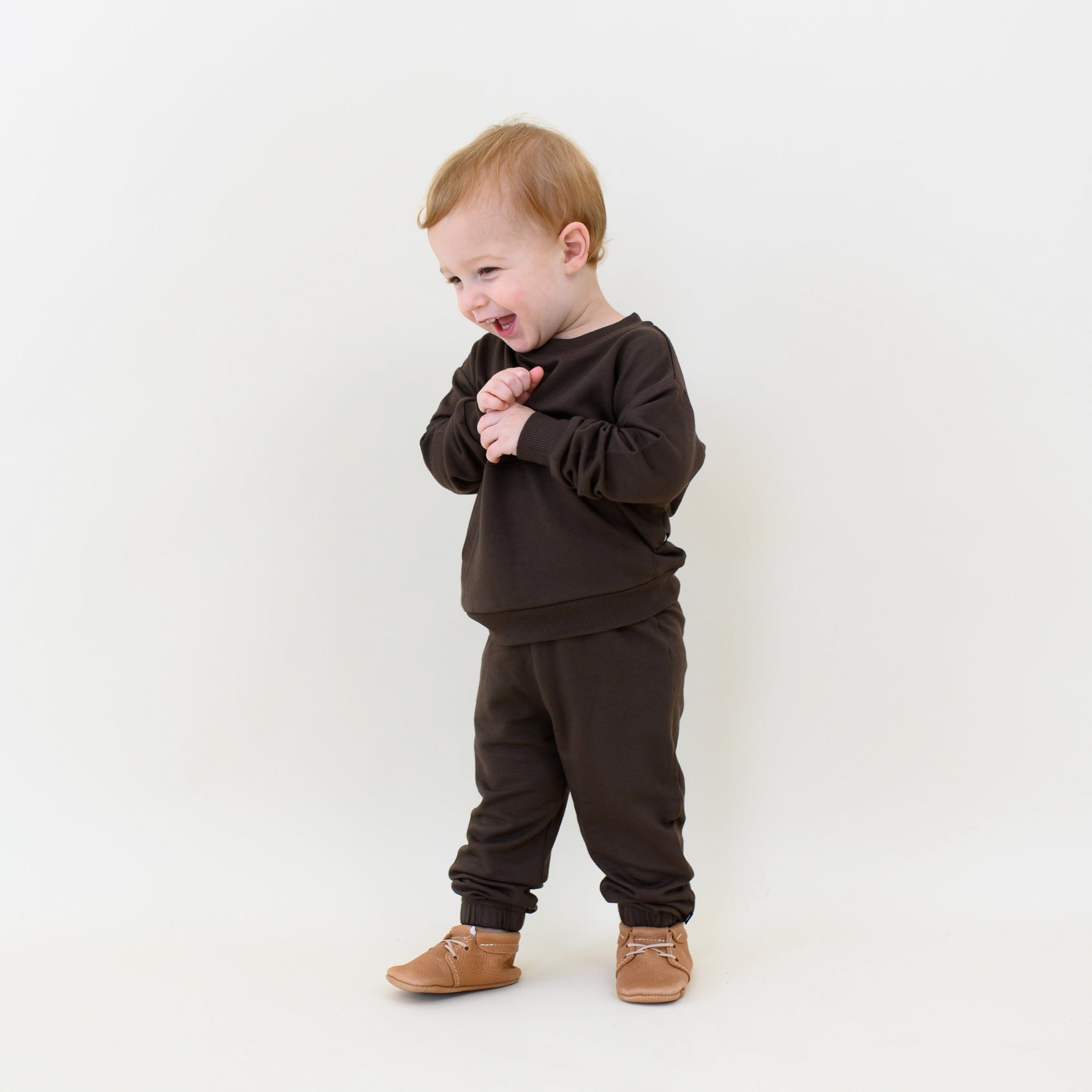 Smiling toddler wearing the French Terry Jogger Set in Espresso