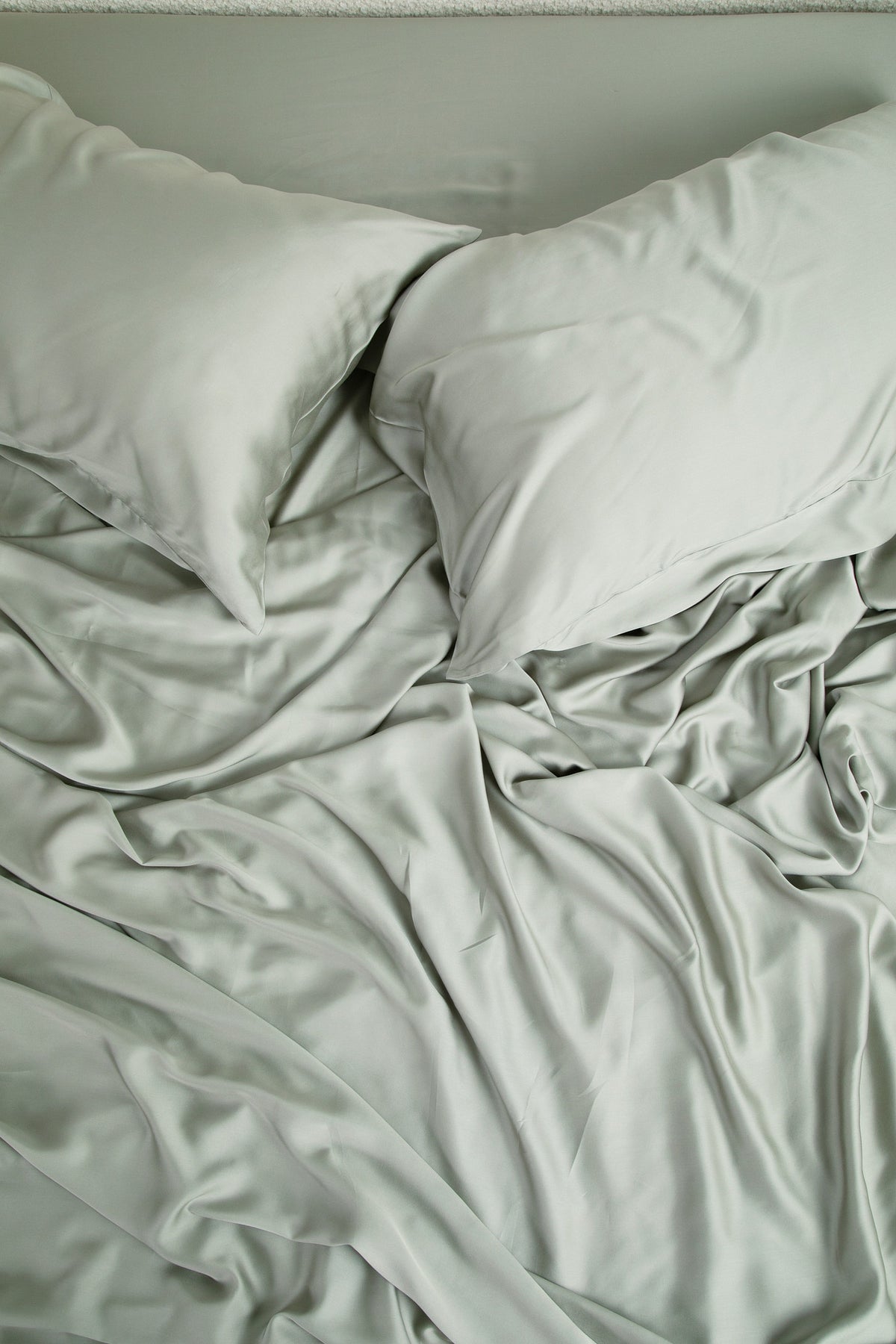 Close up of the Bamboo Sateen Sheet Set in Eucalyptus shown on a bed