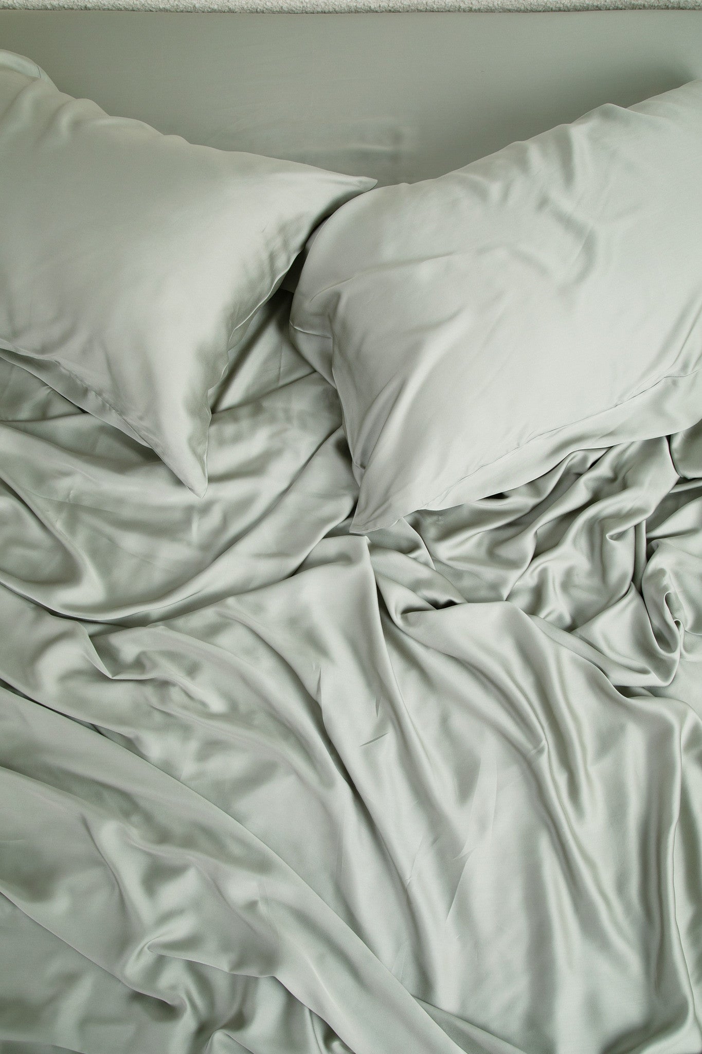 Close up of the Bamboo Sateen Sheet Set in Eucalyptus shown on a bed