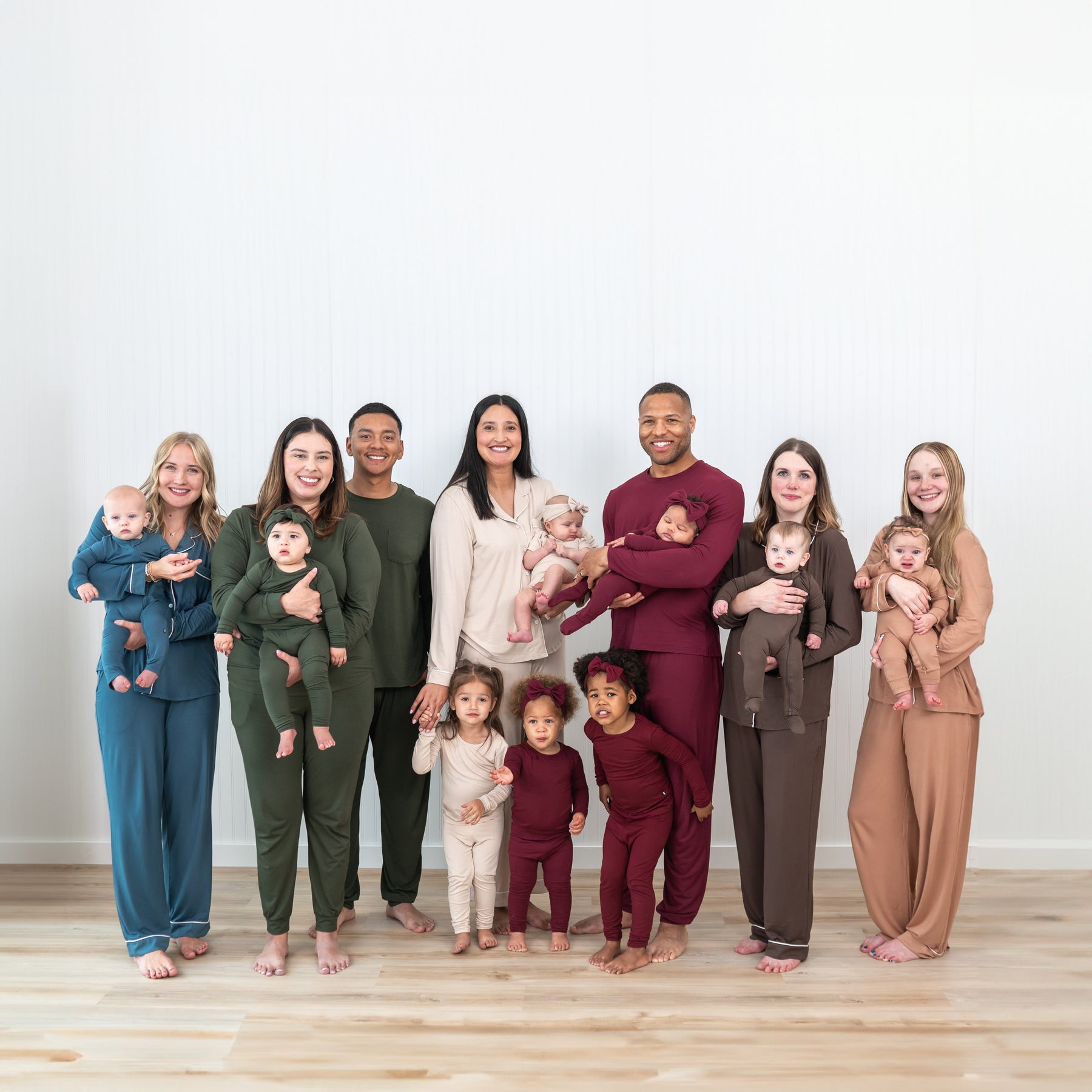 A group shot of 6 families each wearing fall colors
