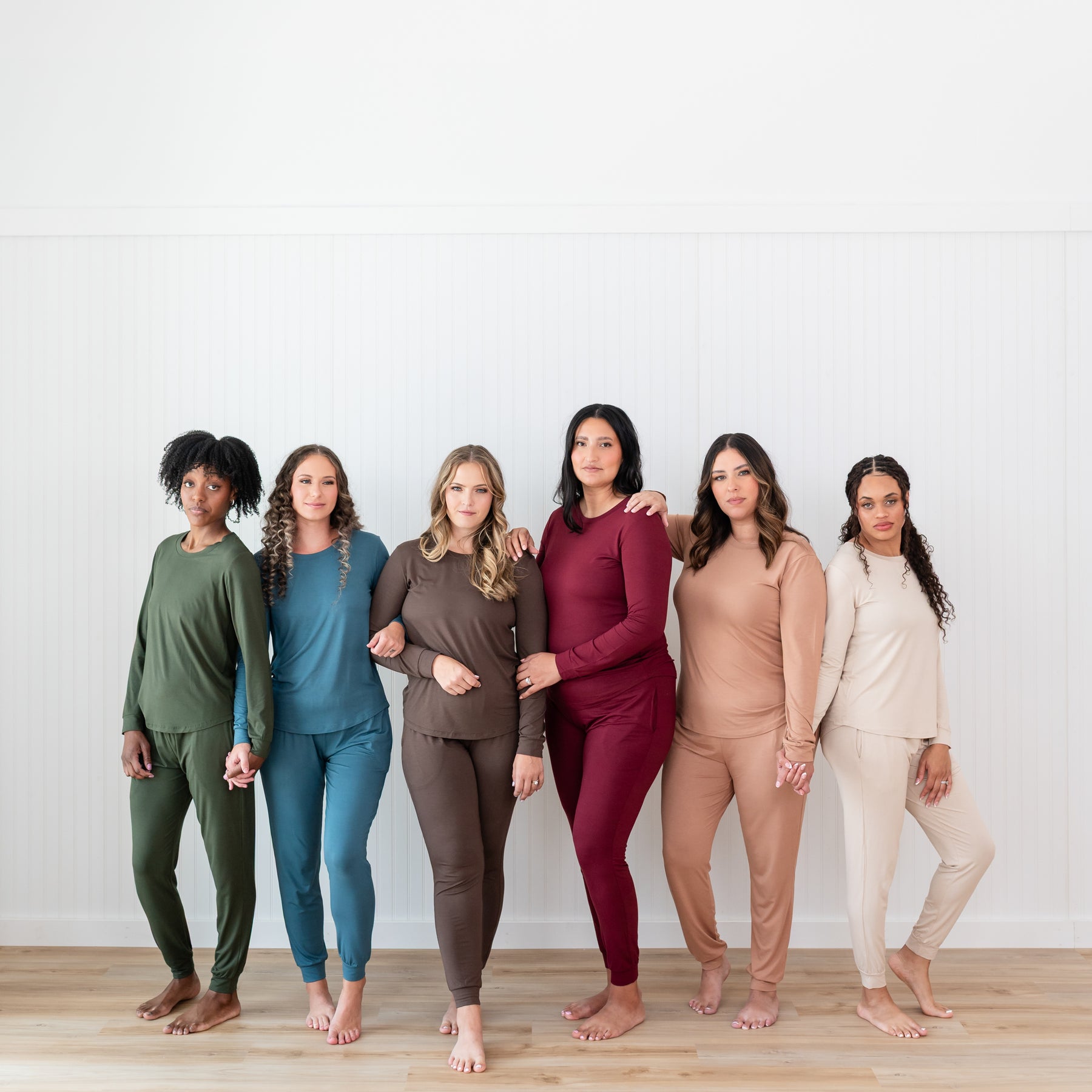 Six women standing side by side wearing the Women's Jogger Pajama Set in the six fall colors