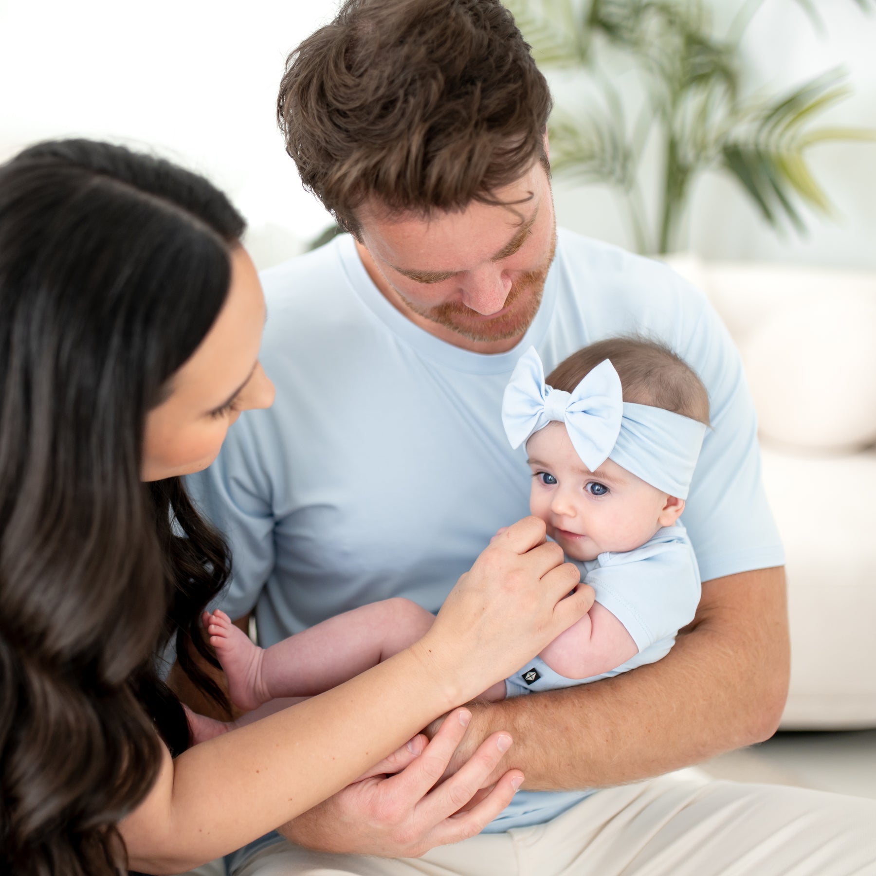 Family of three matching in Breeze with the infant wearing the Bow Headband in Breeze