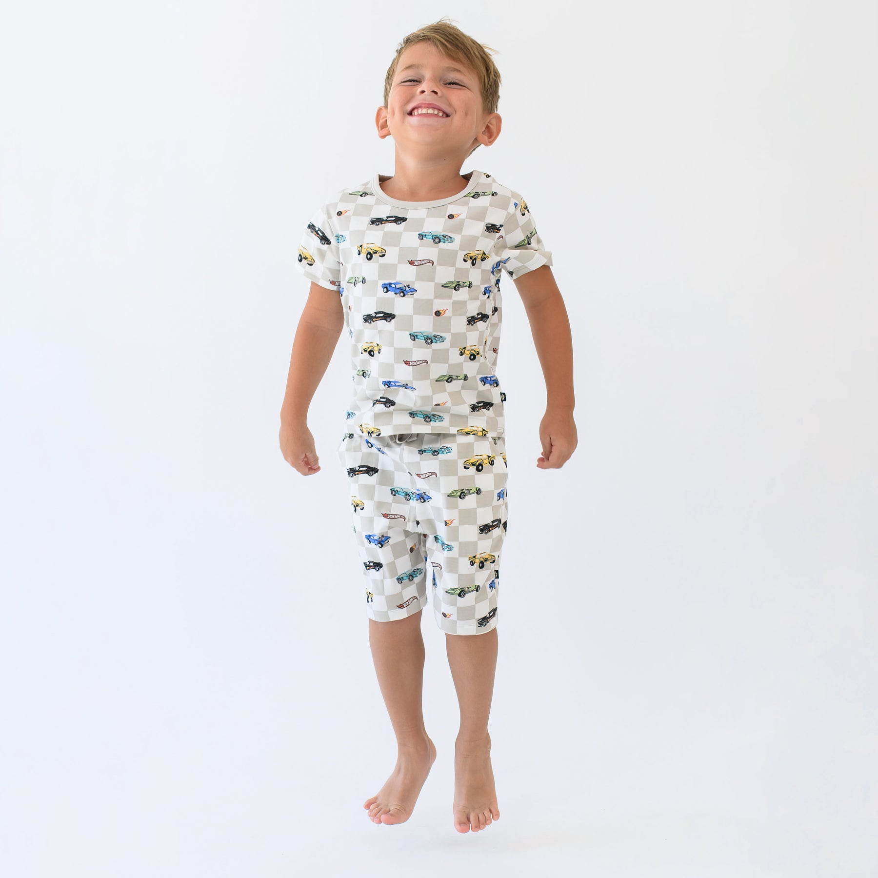 Young smiling boy jumping wearing the Short Sleeve Pajamas in Fast and Fierce