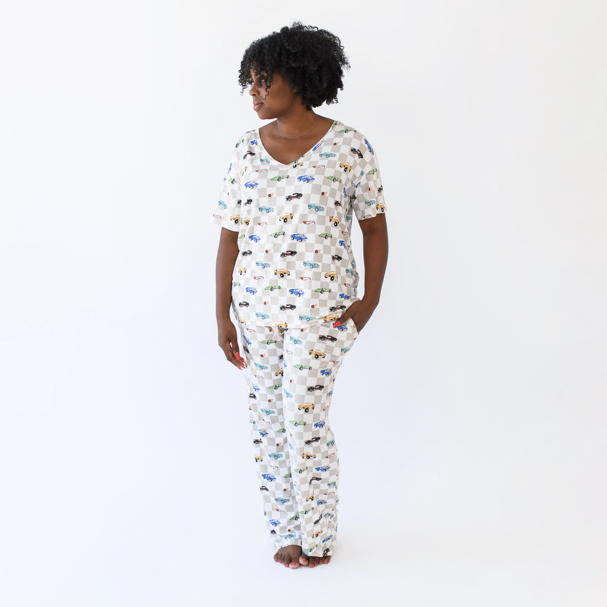 Female model standing wearing the Women's Lounge Pants in Fast and Fierce paired with a matching women's relaxed v-neck