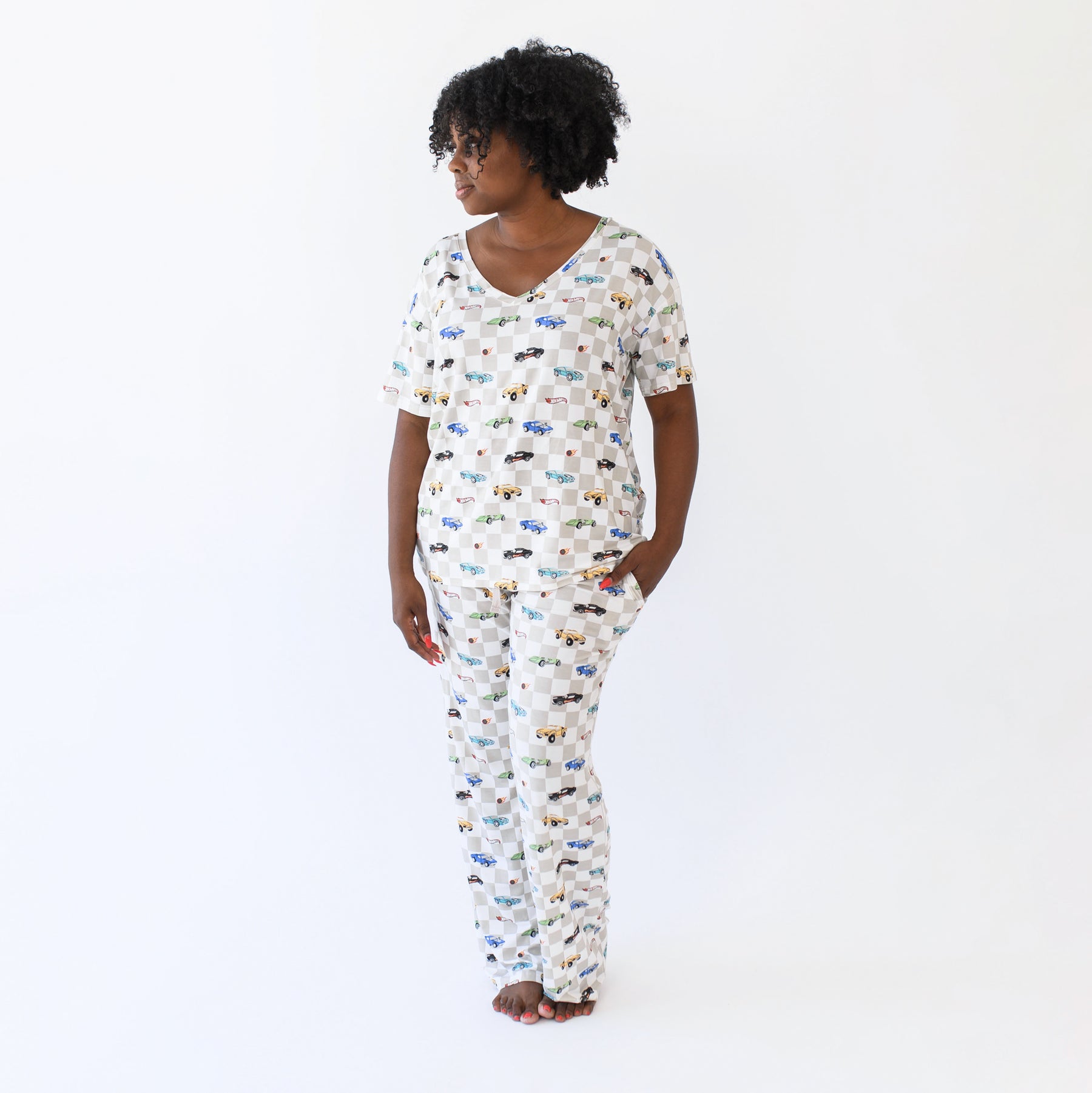 Female model standing wearing the Women's Lounge Pants in Fast and Fierce paired with a matching women's relaxed v-neck