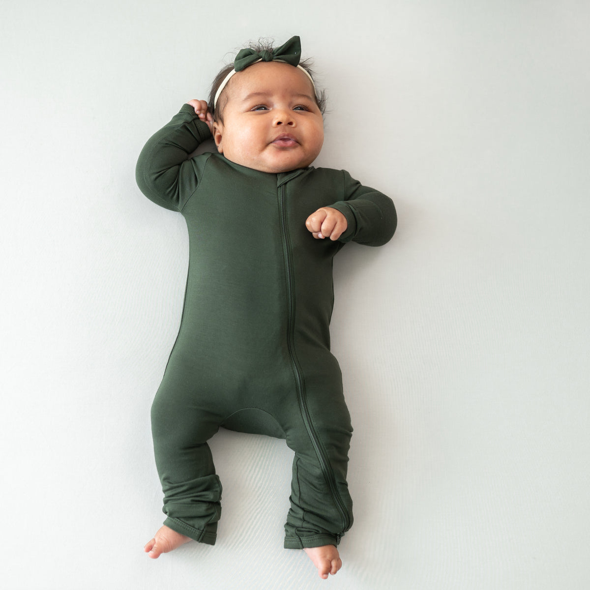 Baby wearing Fir Zippered Romper and matching Tiny Bow