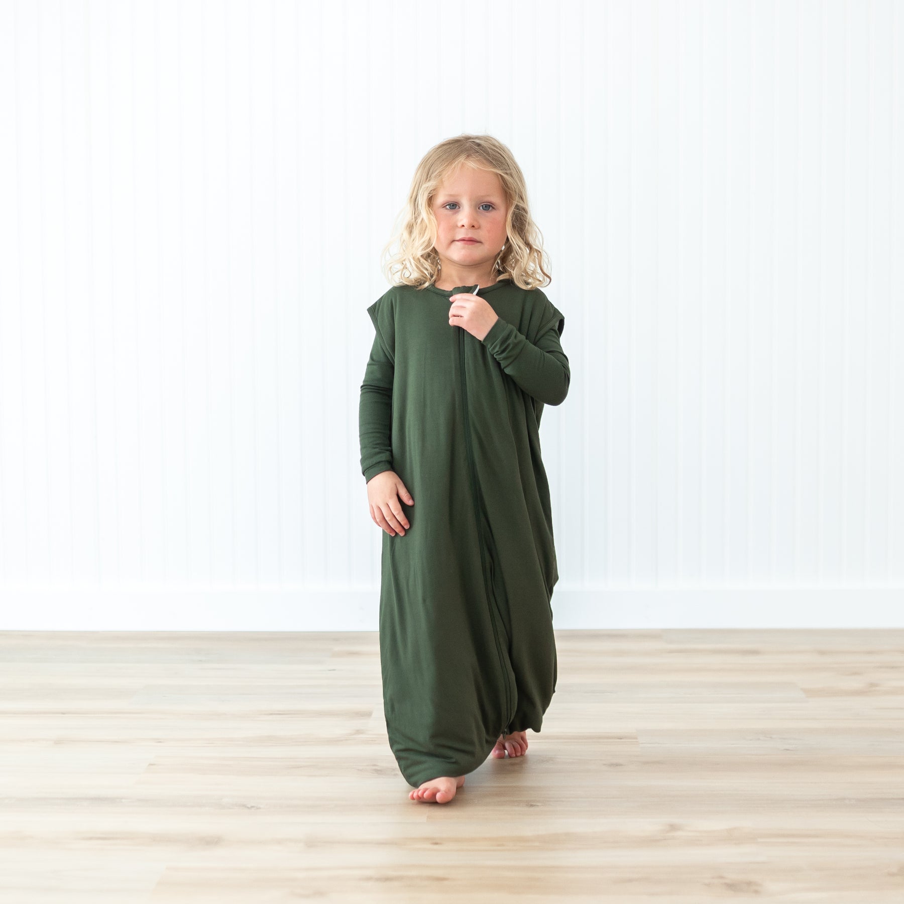 Toddler wearing Sleep Bag Walker in Fir 1.0 in a neutral studio setting