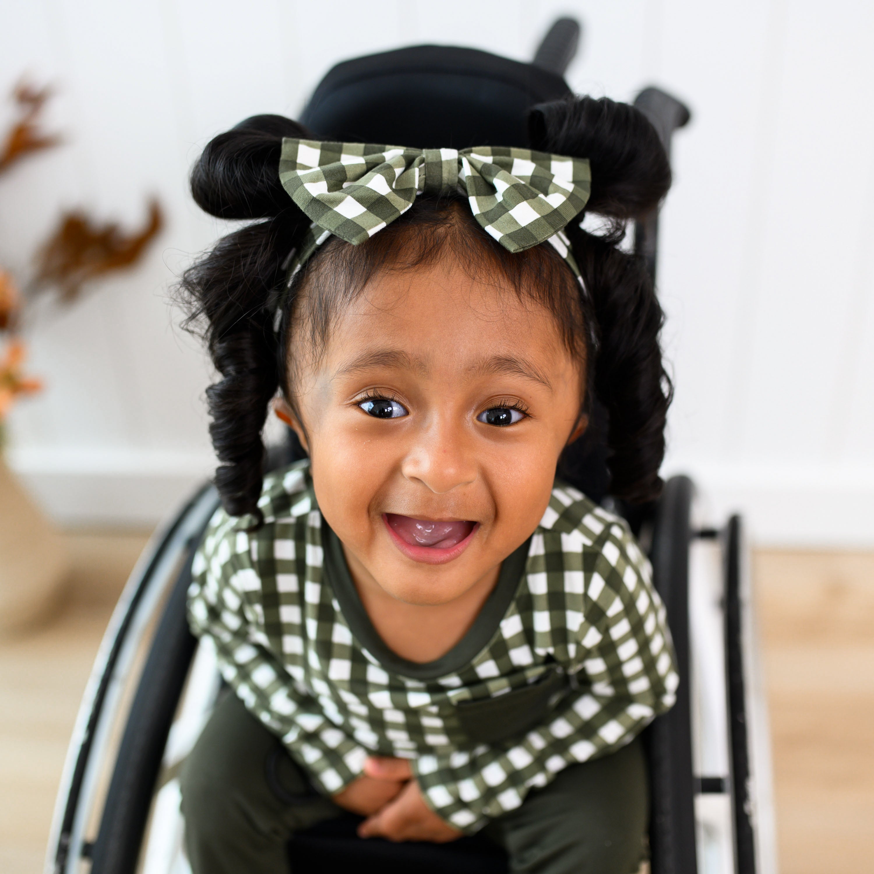 Girl wearing Bow Headband in Gingham Fir and matching long sleeve crew neck tee