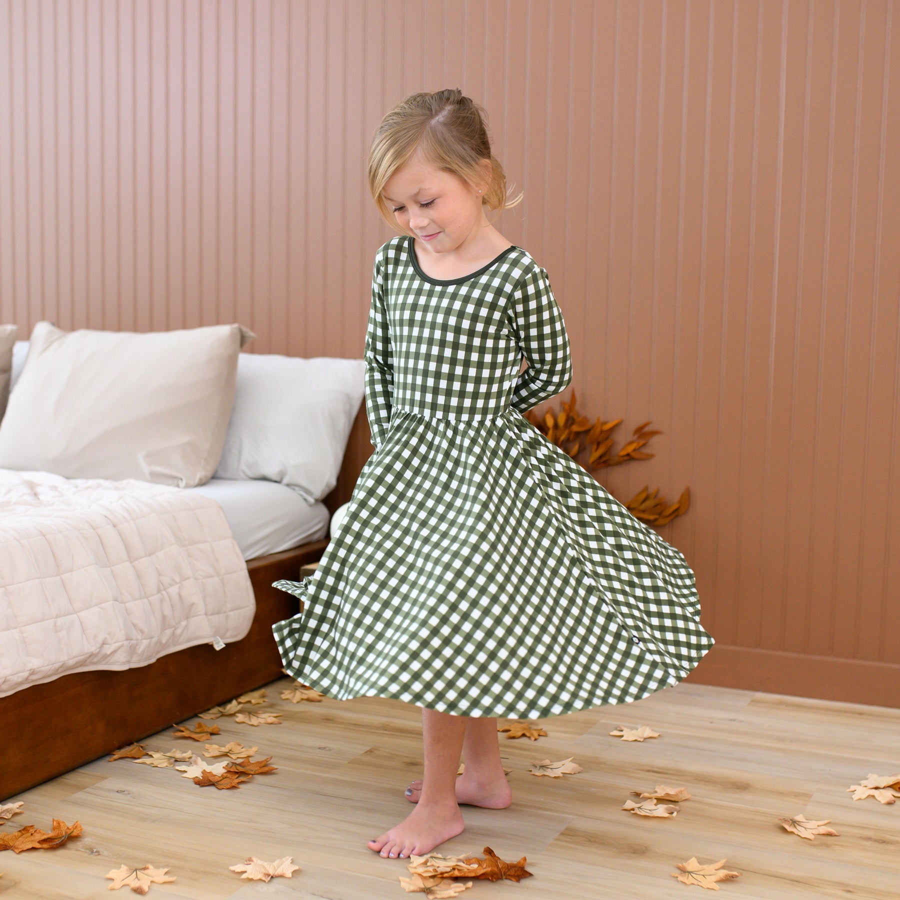 Girl twirling in the Long Sleeve Twirl Dress in Gingham Fir