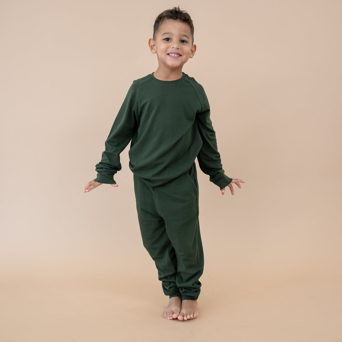 Child wearing the Bamboo Jersey Jogger Set in Fir green