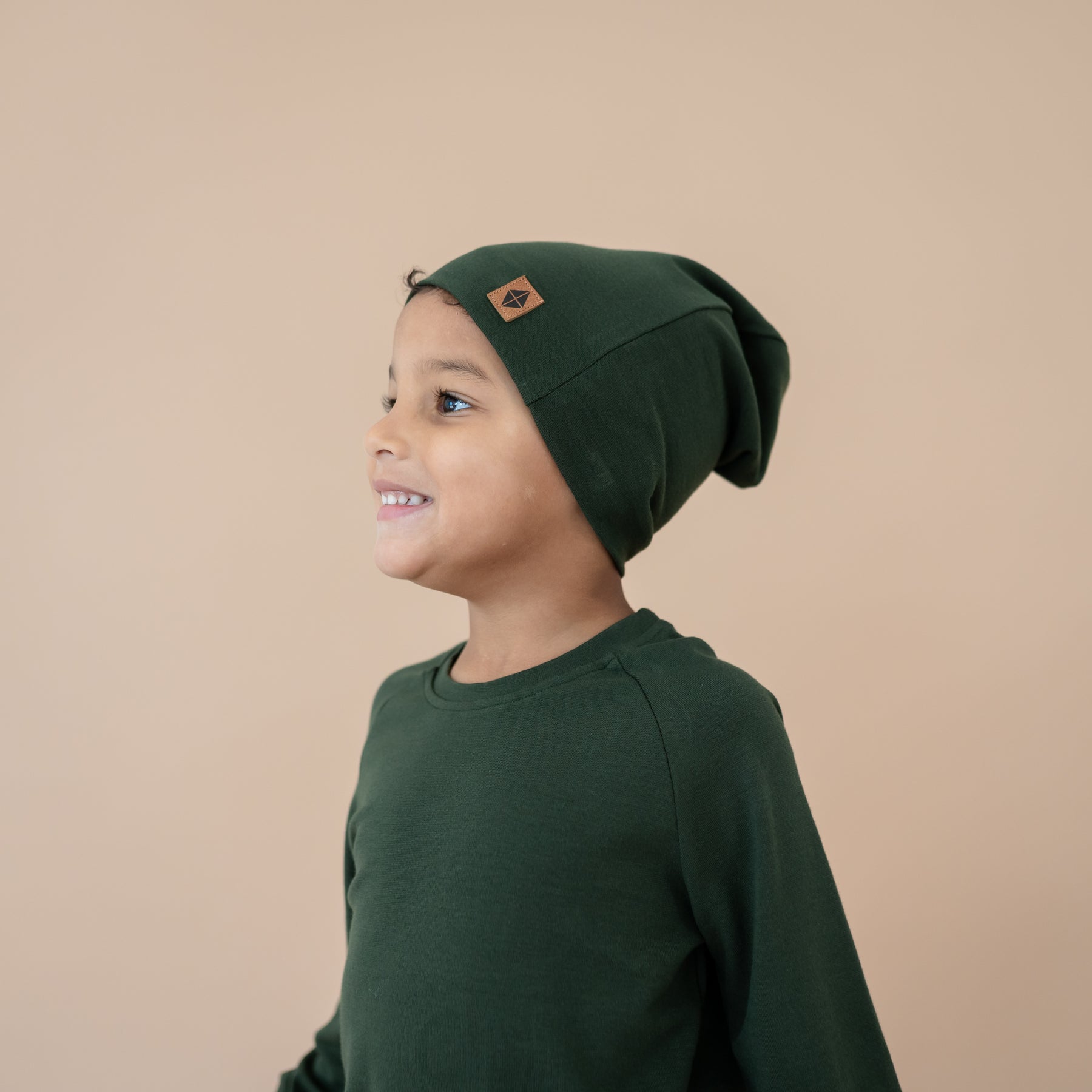 Child wearing Bamboo Jersey Beanie in Fir and matching jogger set