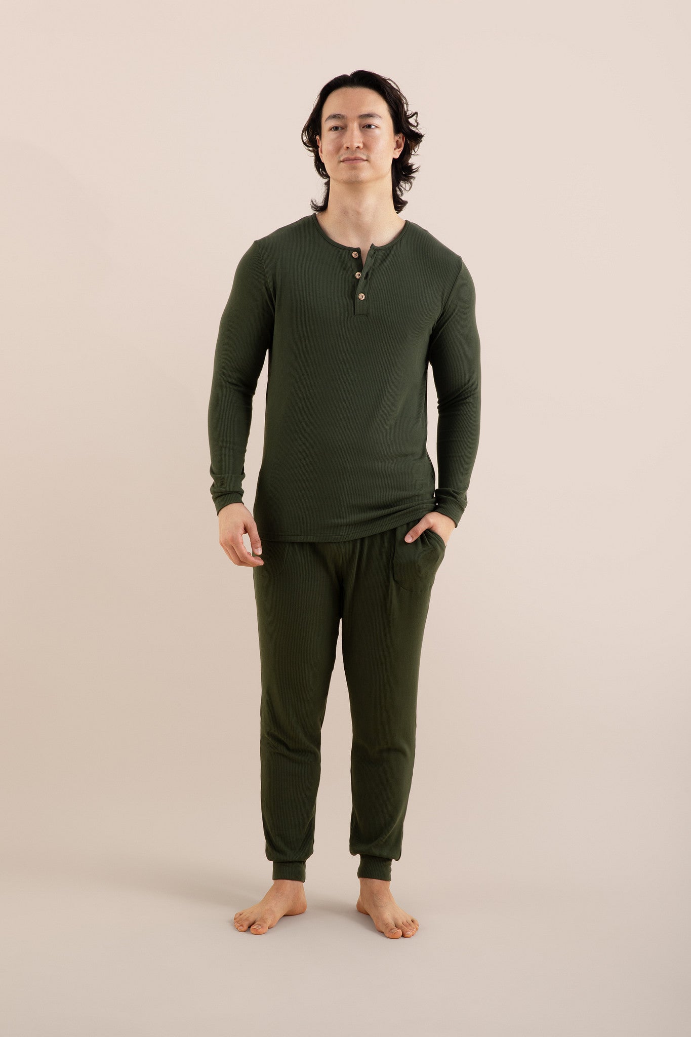 Male modeling the Men's Ribbed Henley Set in Fir with one hand in the pants pocket