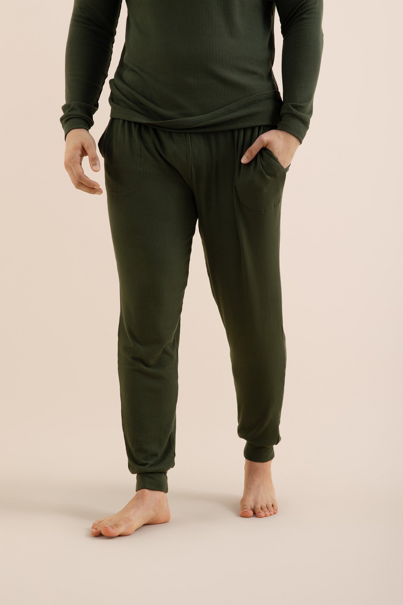 The pants of the Men's Ribbed Henley Set in Fir shown on a model
