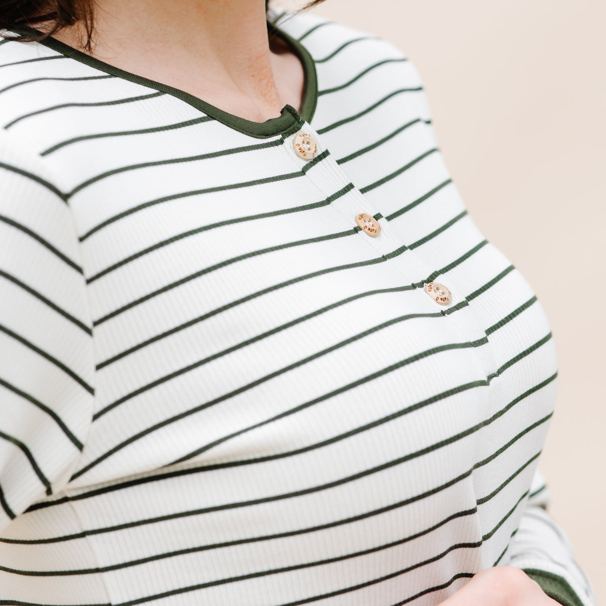 Close up of the button placket showing the Kyte Baby engraved buttons on the Women’s Ribbed Henley Set in Fir Stripe