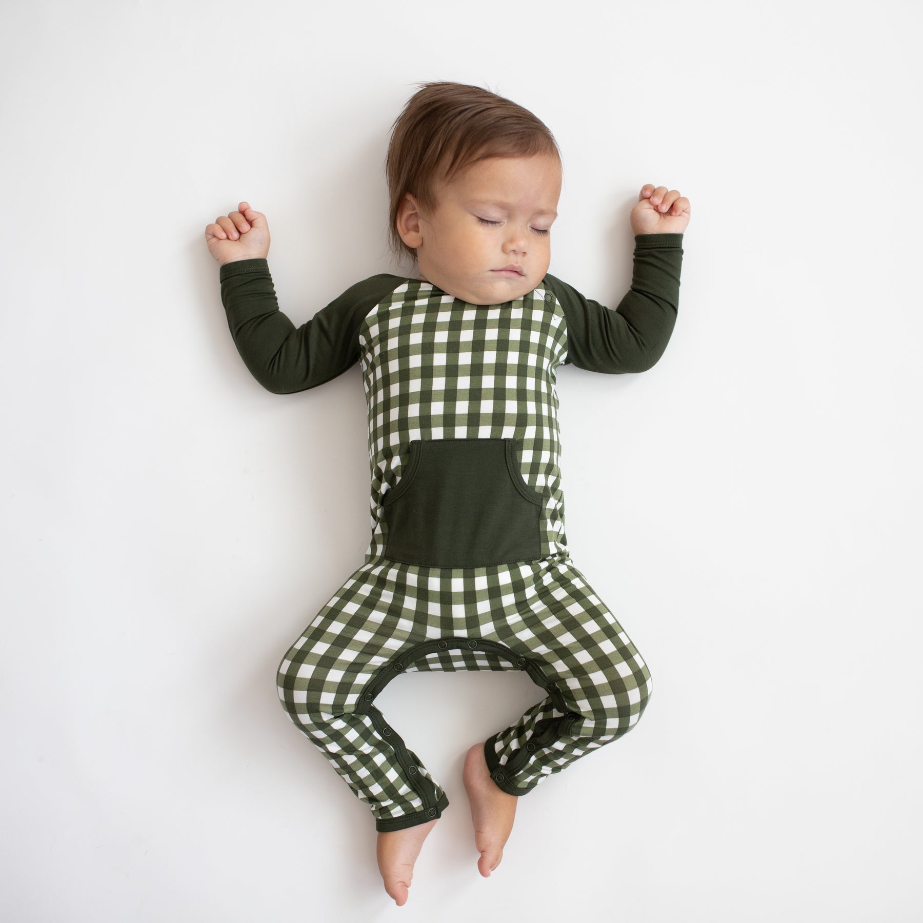 Sleeping toddler wearing the Longall in Gingham Fir