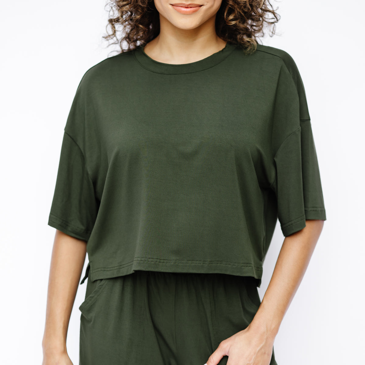 Close up of the Women's Short Sleeve Tee in Fir shown on a model