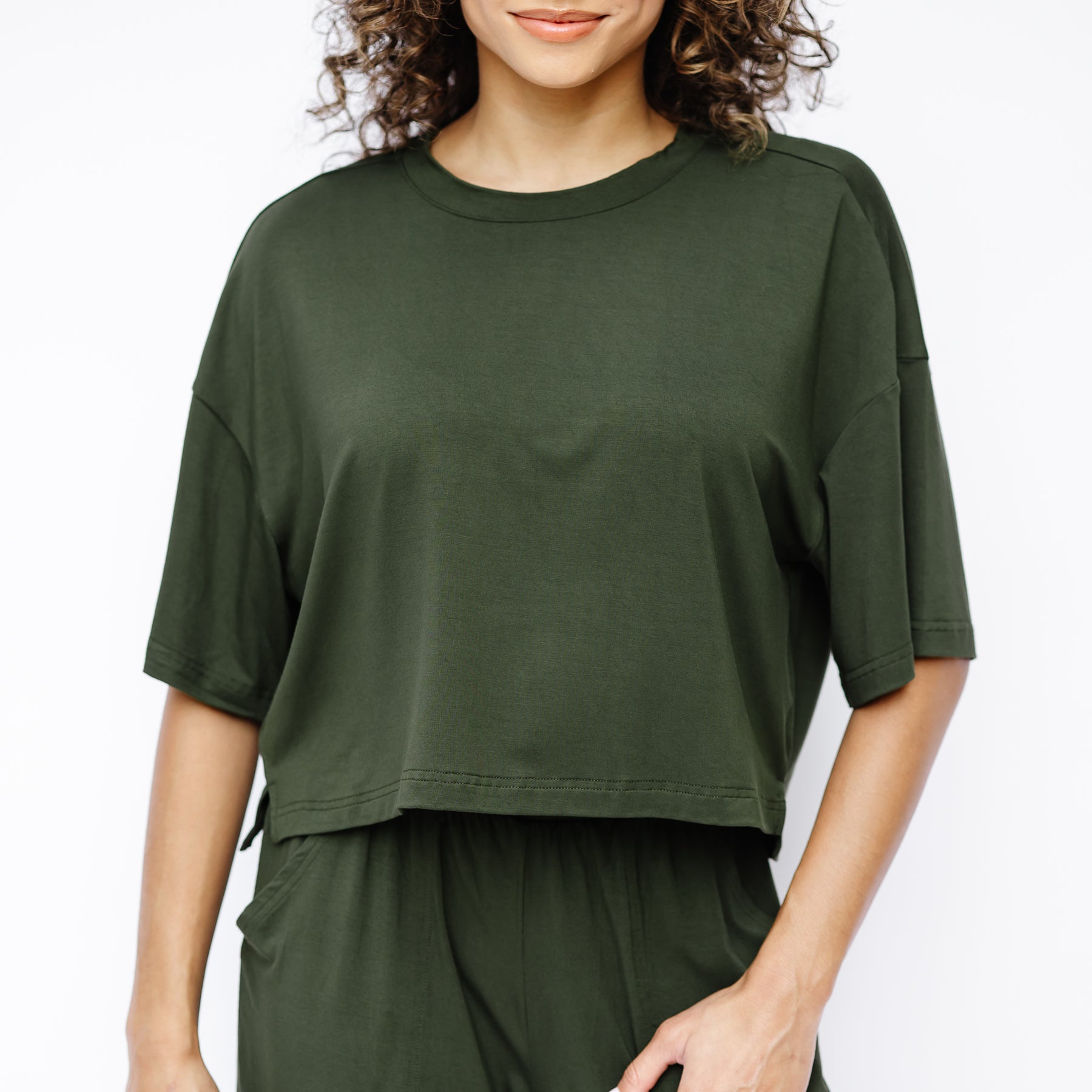 Close up of the Women's Short Sleeve Tee in Fir shown on a model