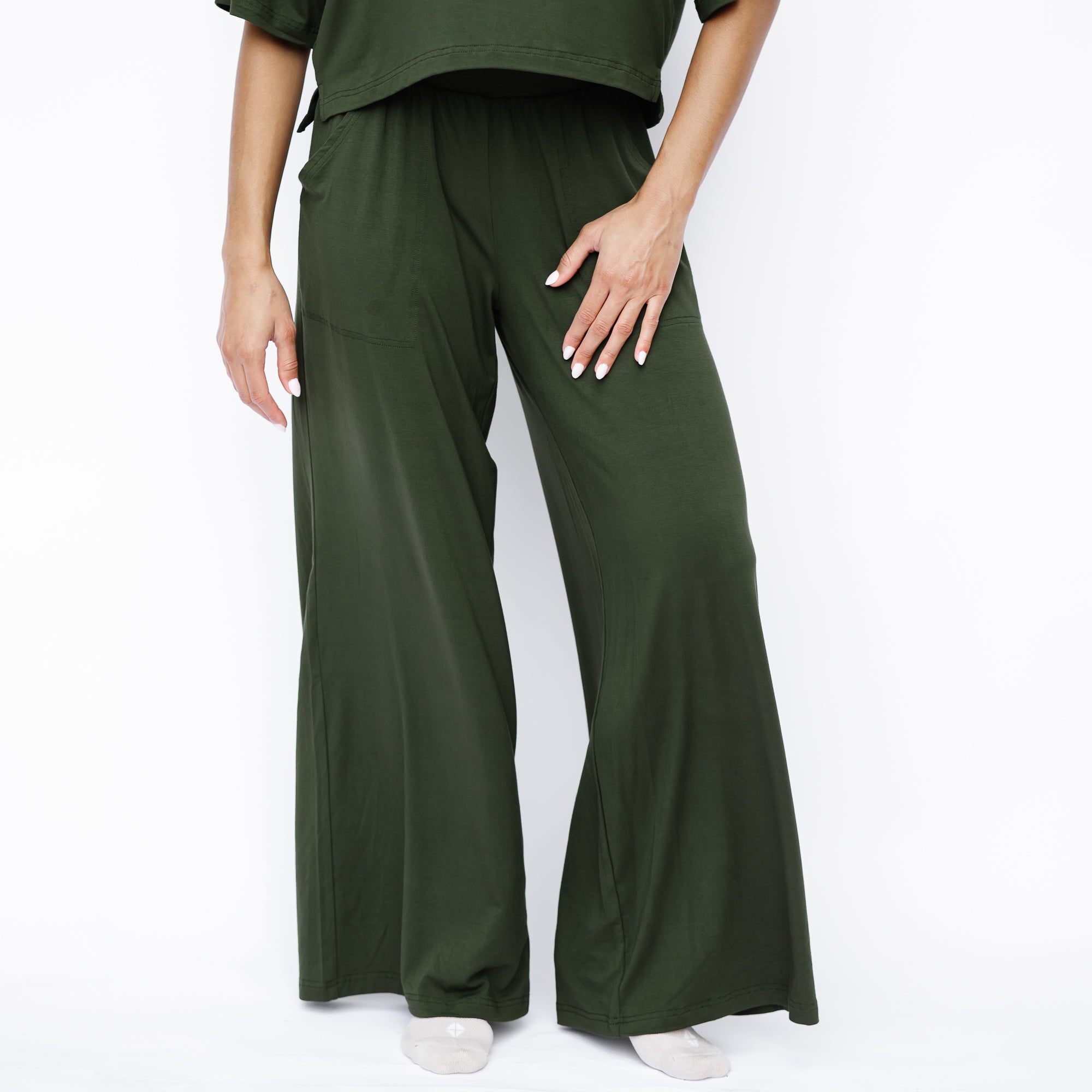 Women's Wide Leg Pant in Fir shown on a female model standing in front of a white background