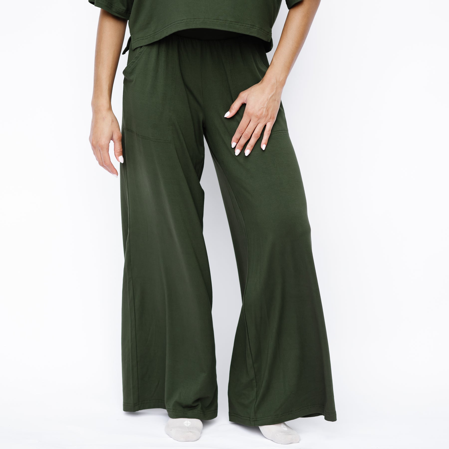 Women's Wide Leg Pant in Fir shown on a female model standing in front of a white background