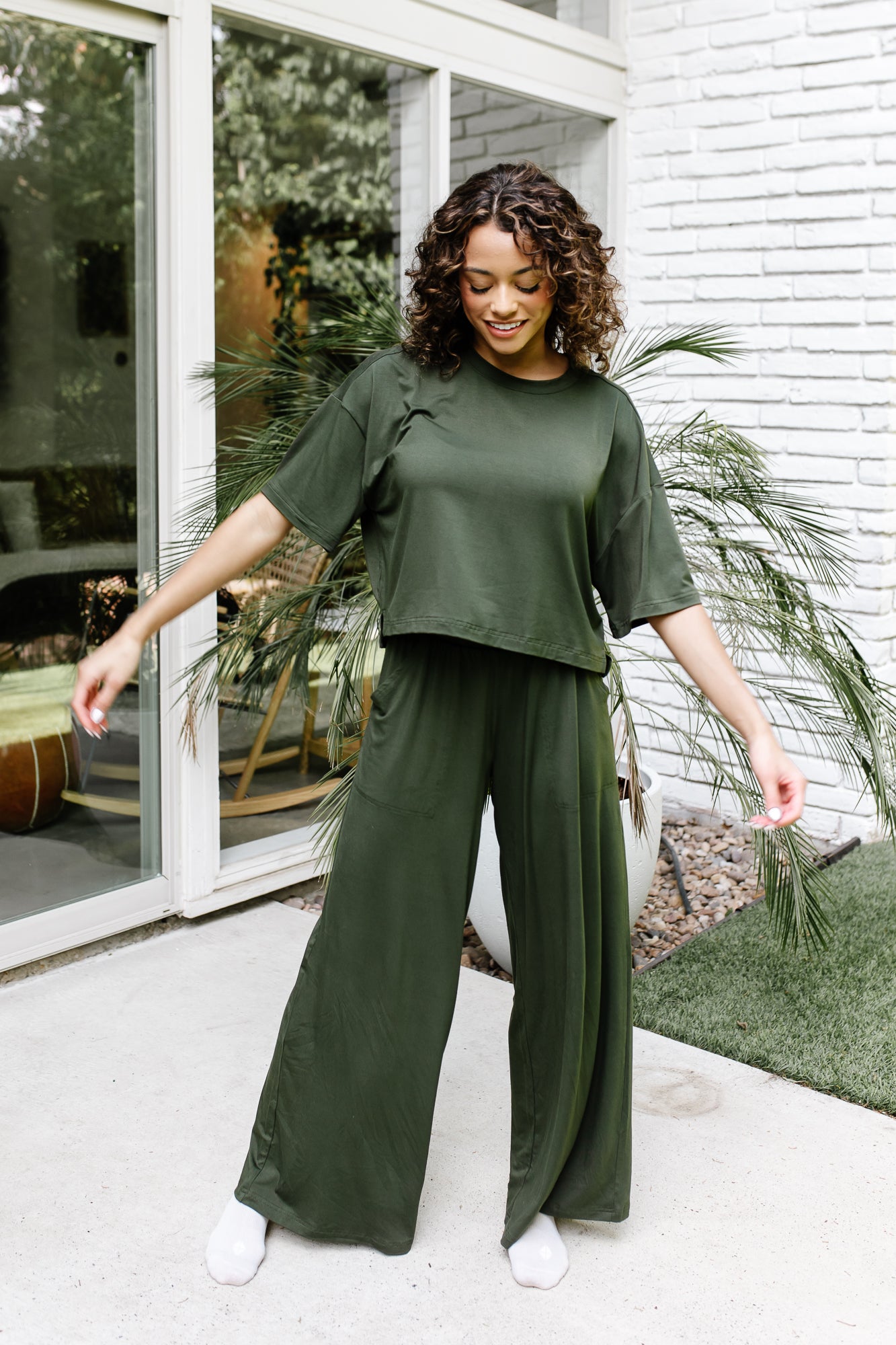 woman in matching set in a deep green color